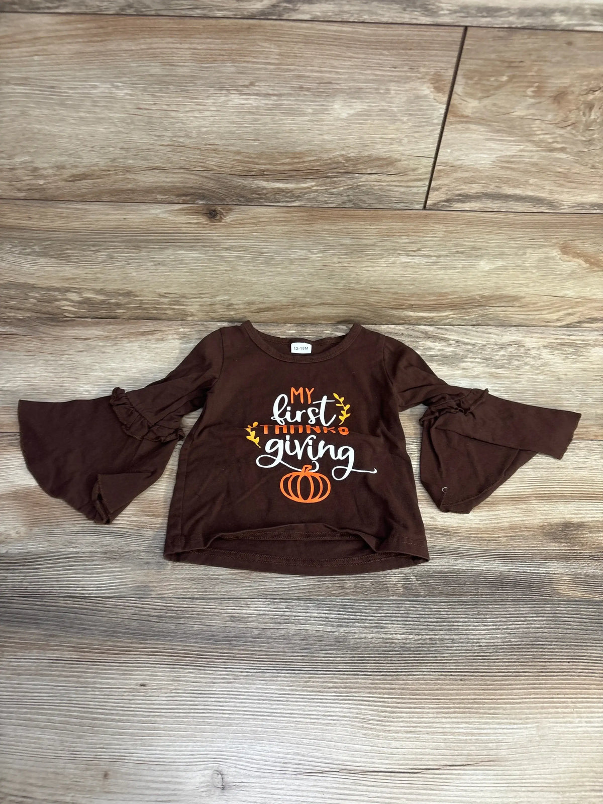 Brown baby shirt with bell sleeves and Thanksgiving-themed text My first Thanksgiving and pumpkin graphic