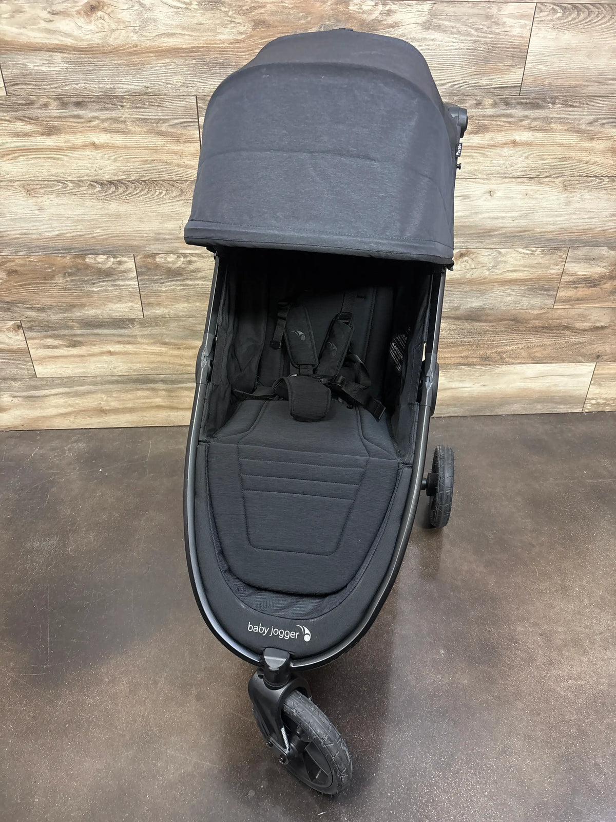 Front view of Baby Jogger City Mini GT2 All Terrain Stroller in Opulent Black showing canopy, padded seat, harness, and wheels