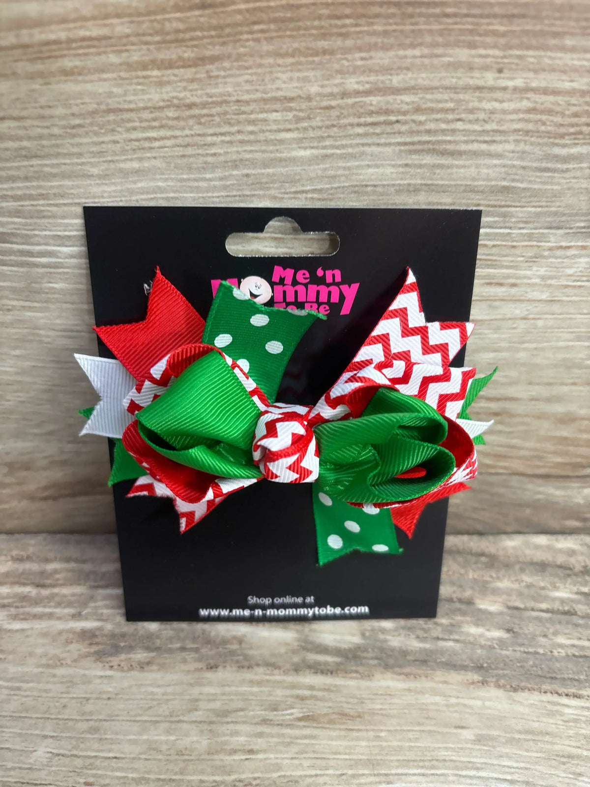 Festive red, green, and white holiday hair bow with polka dot and chevron patterns