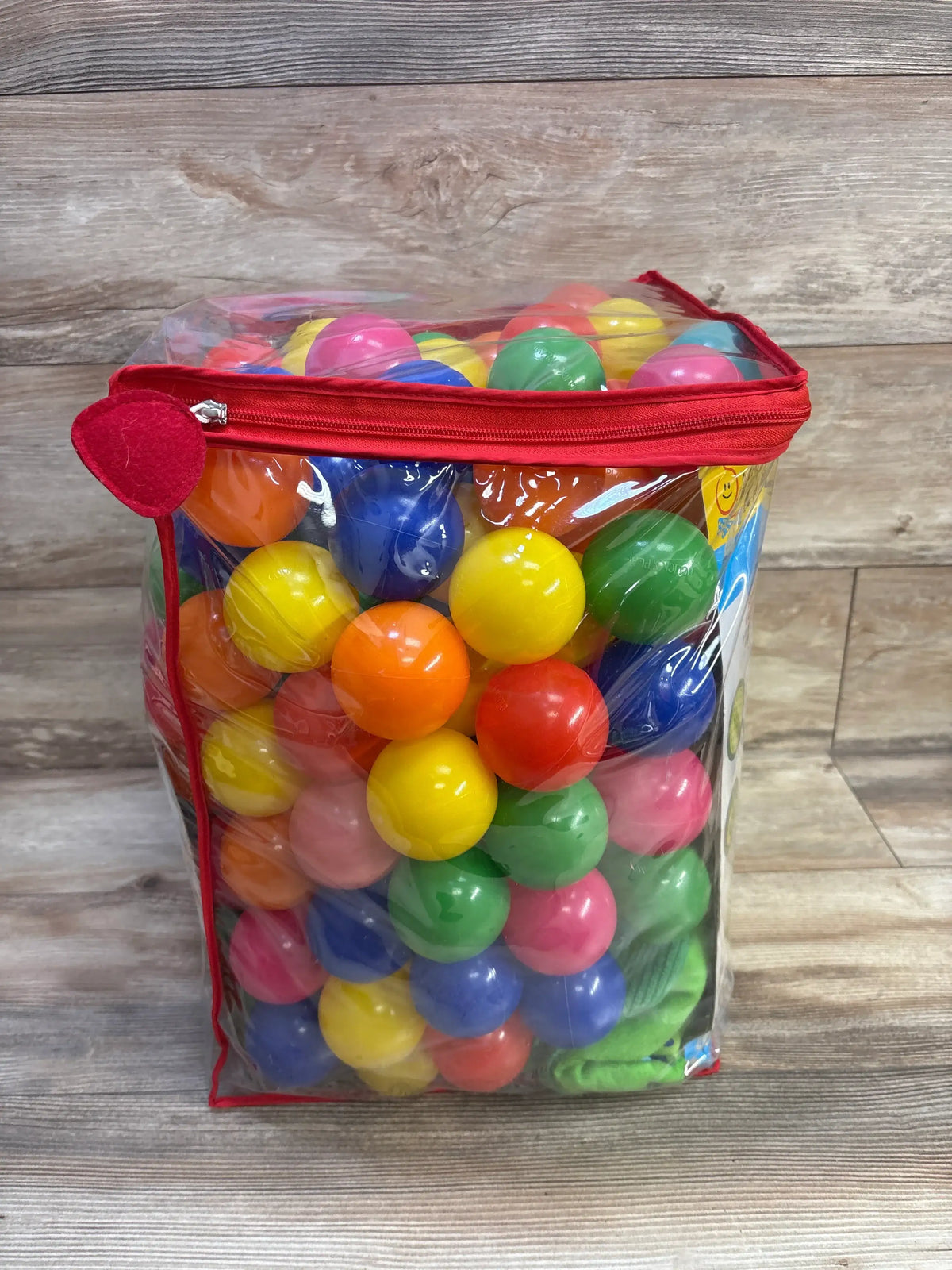 Front view of Melissa & Doug K’s Kids Turtle Ball Pit with 180 Balls showcasing colorful balls in a clear red-zippered bag