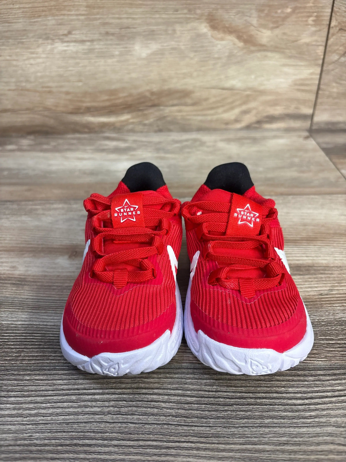 Front view of Nike Star Runner 4 TD University Red sneakers showcasing red mesh uppers and white rubber outsoles