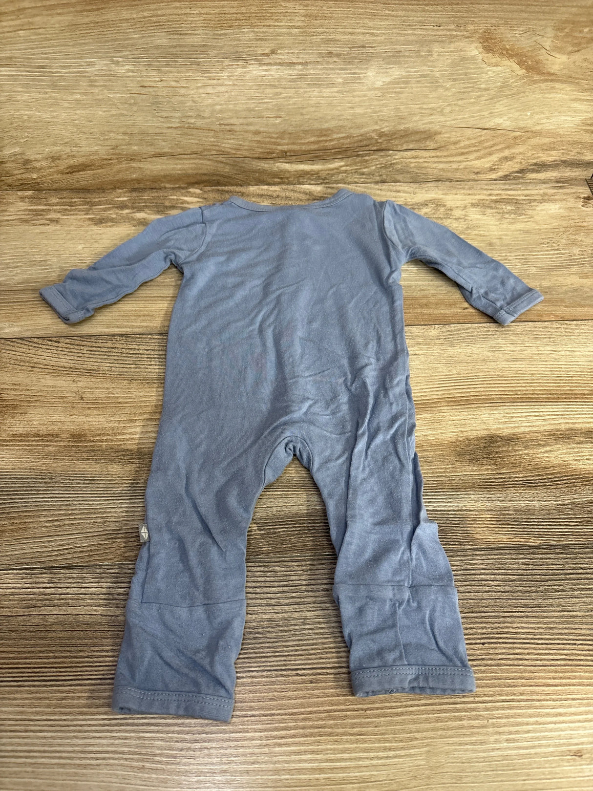 Blue long sleeve baby romper laid flat on wooden surface, secondhand kids clothing