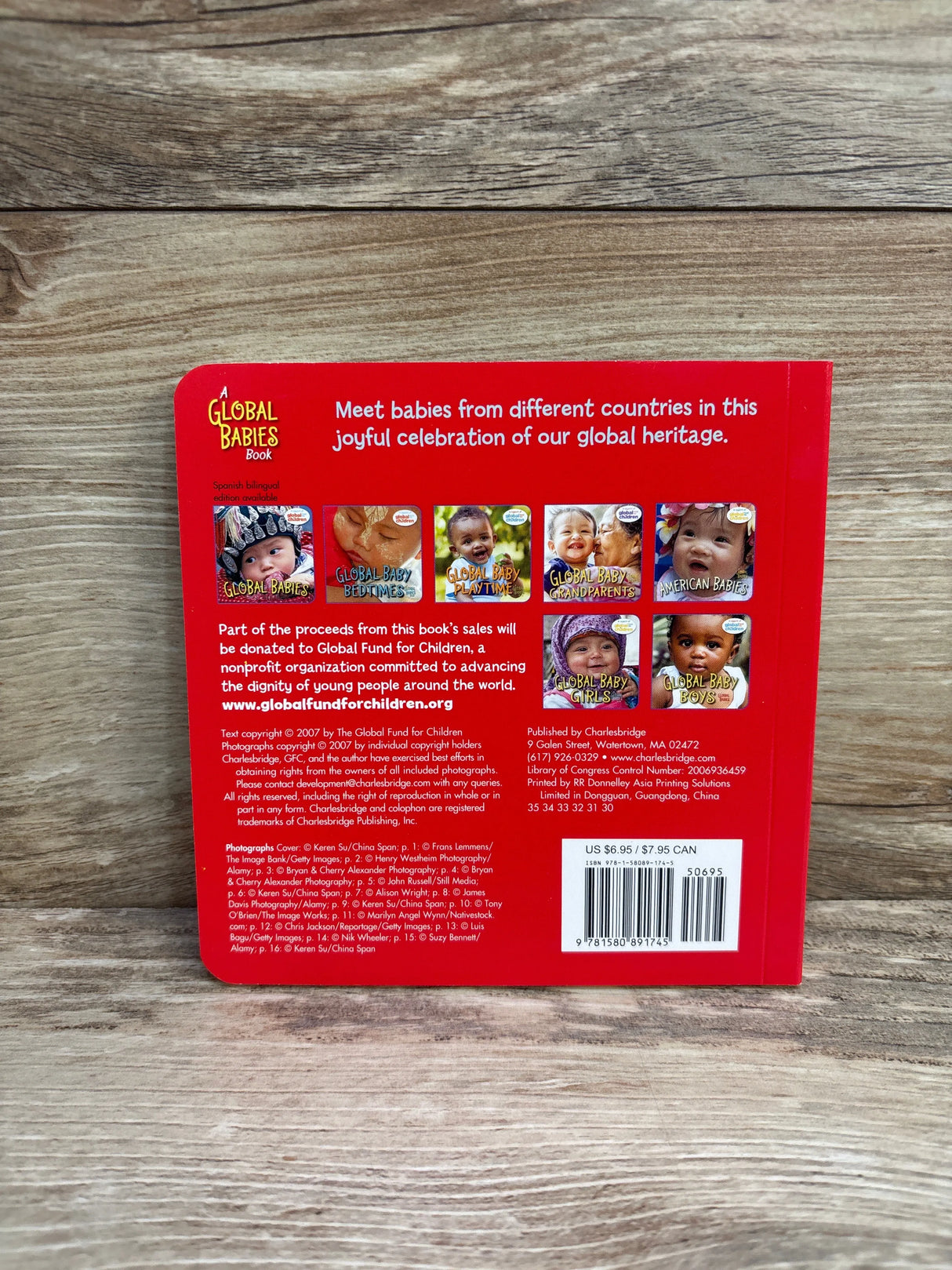 Back cover of a red Global Babies book featuring diverse baby photos and fundraiser info for Global Fund for Children