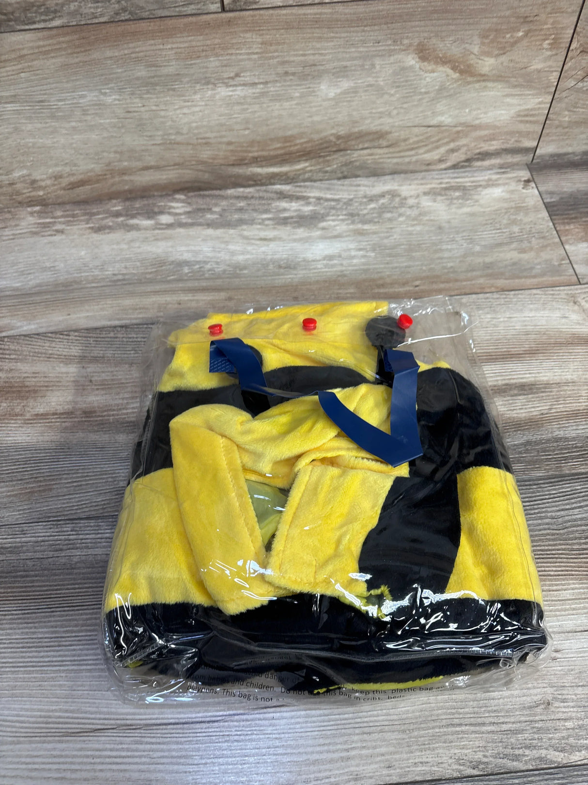 Yellow and black bee costume for kids, packaged in plastic, perfect for Halloween or dress-up play