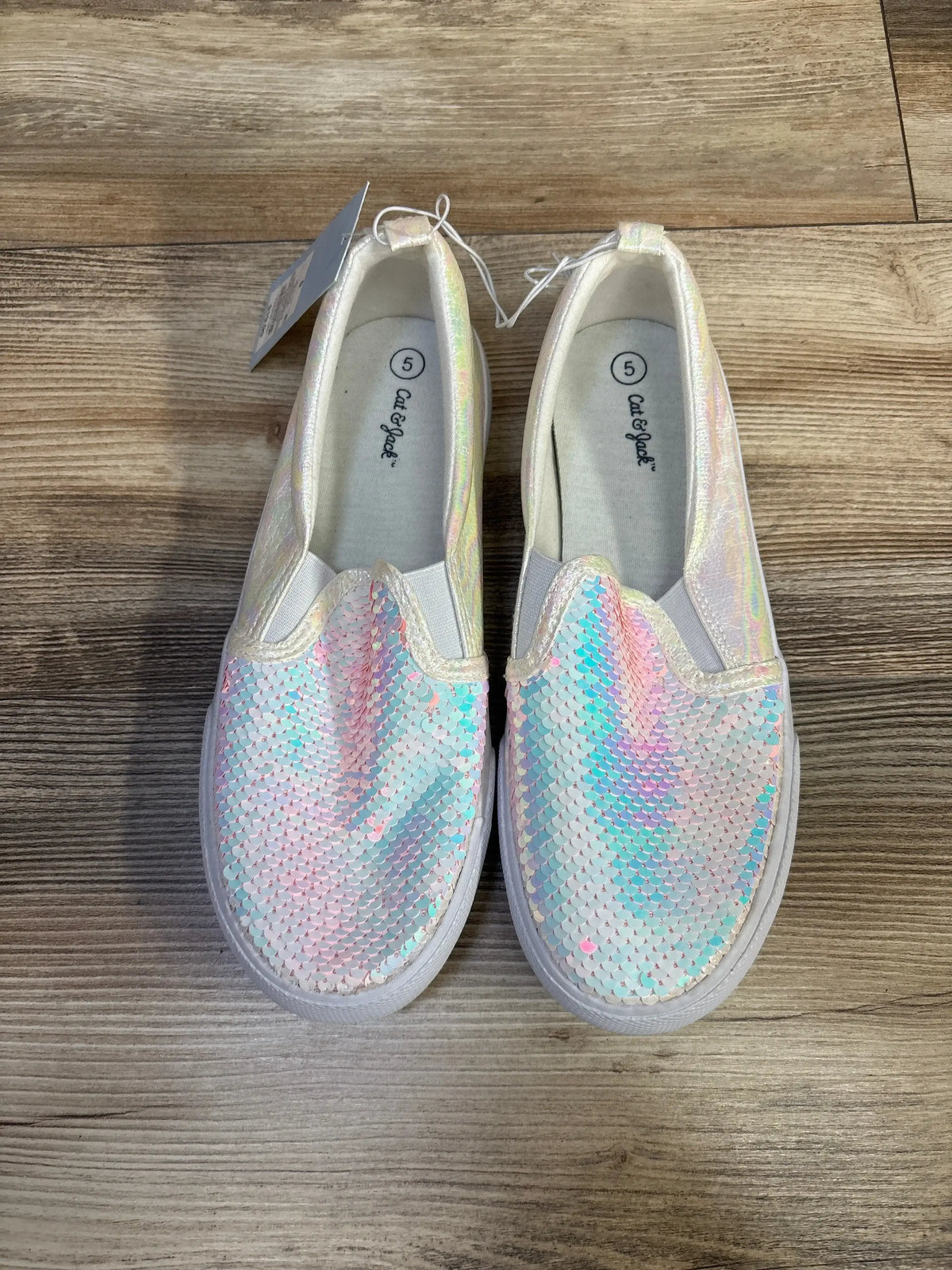 Three-quarter view of Cat & Jack Aliki toddler slip-on sneakers, white sequined upper with elastic side panels on white background