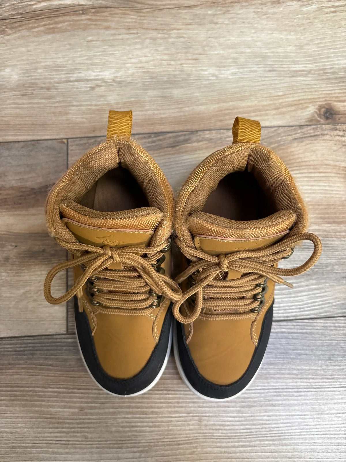 Top view of Beverly Hills Polo Flynn casual boot tan size 12C showcasing lace-up front and black toe trim on wood floor