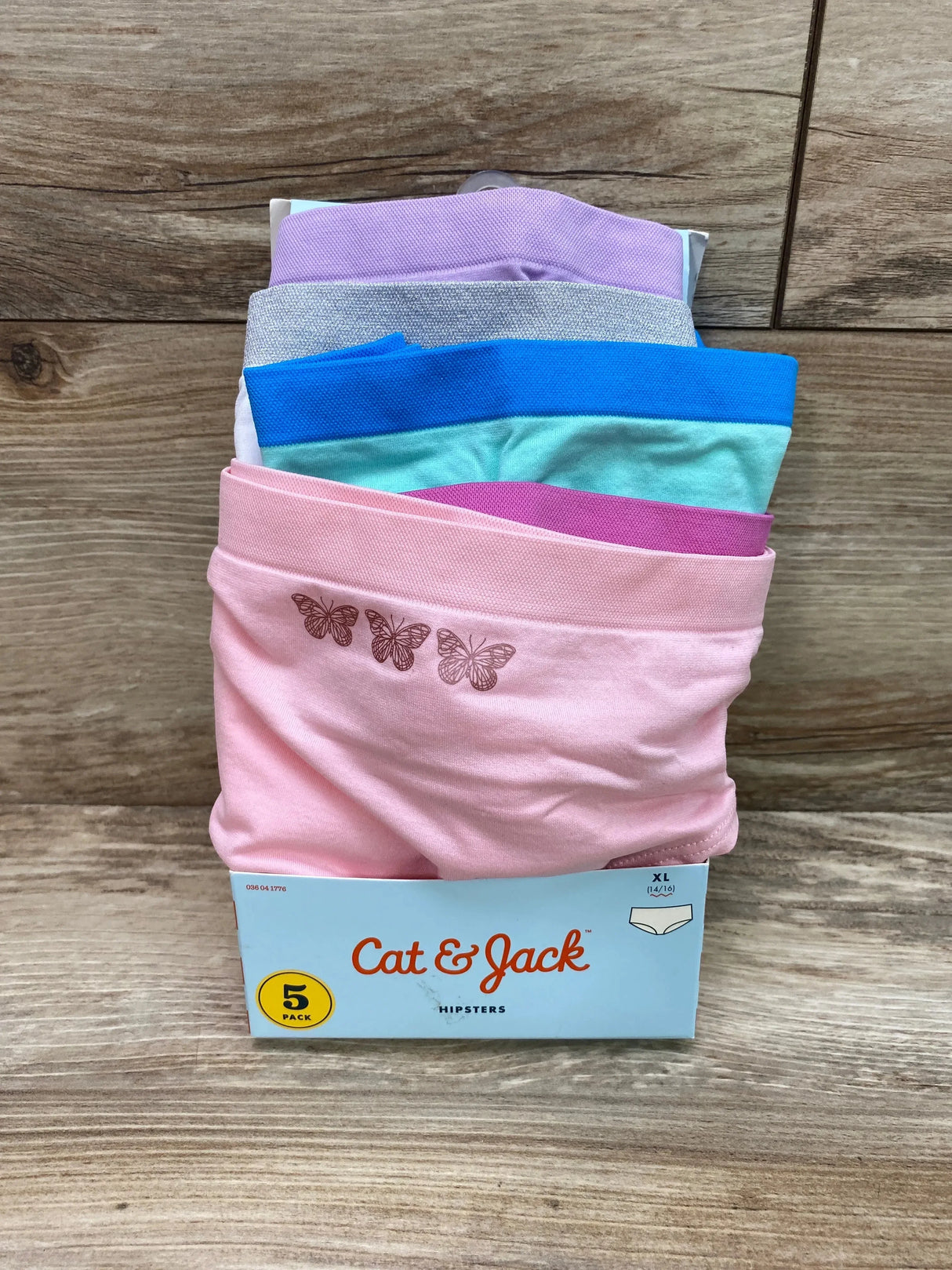 Front of Cat and Jack 5-pack hipster underwear in pastels with butterfly print on pink pair, packaged on wood