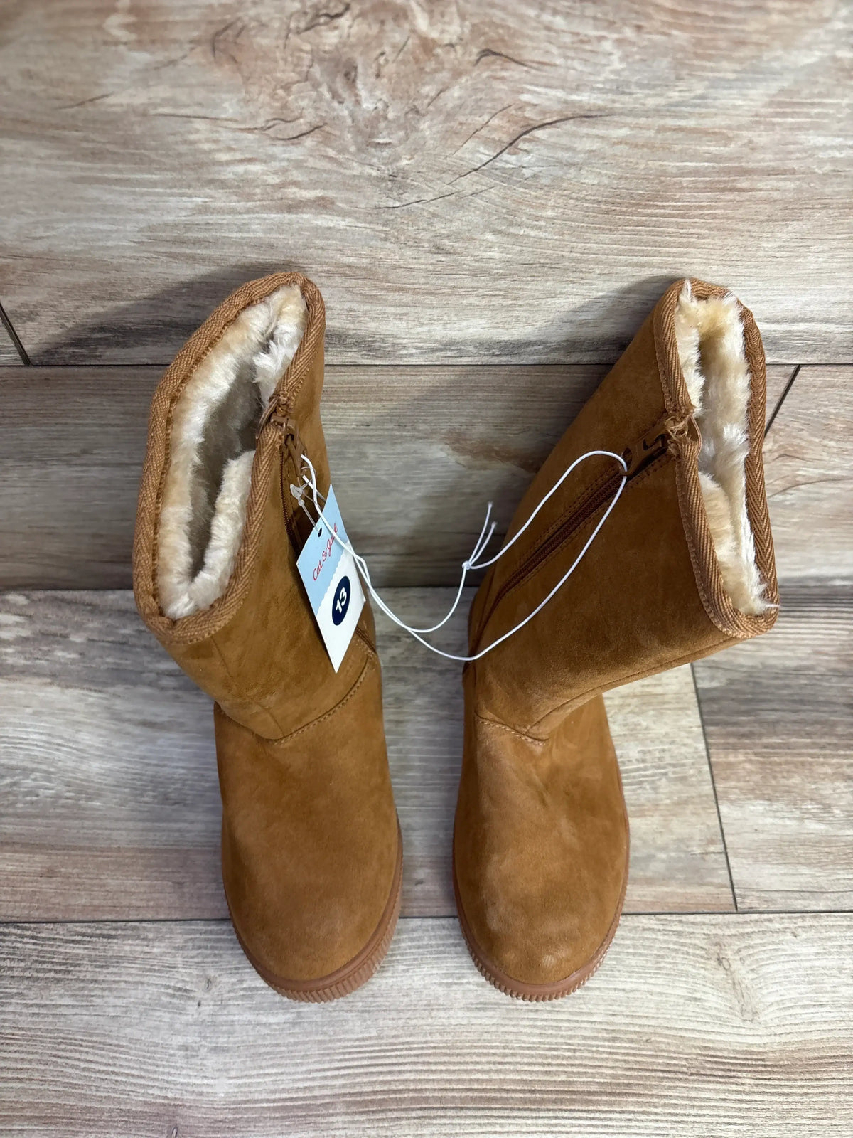 Kids brown suede faux fur winter boots with zipper detail on wooden floor