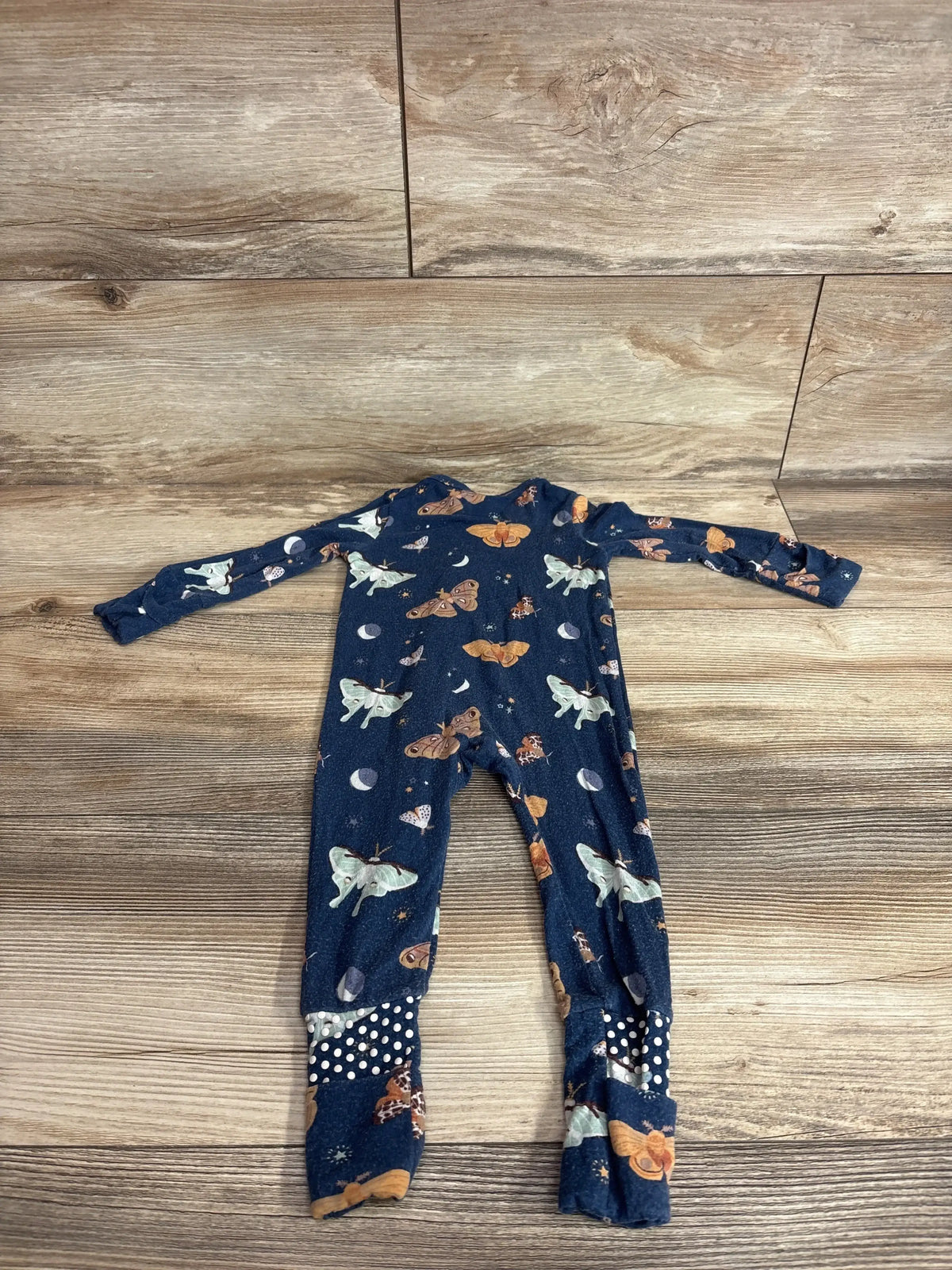 Front view of Angel Dear bamboo convertible zip sleeper in navy showing butterfly graphic and front zipper on white background