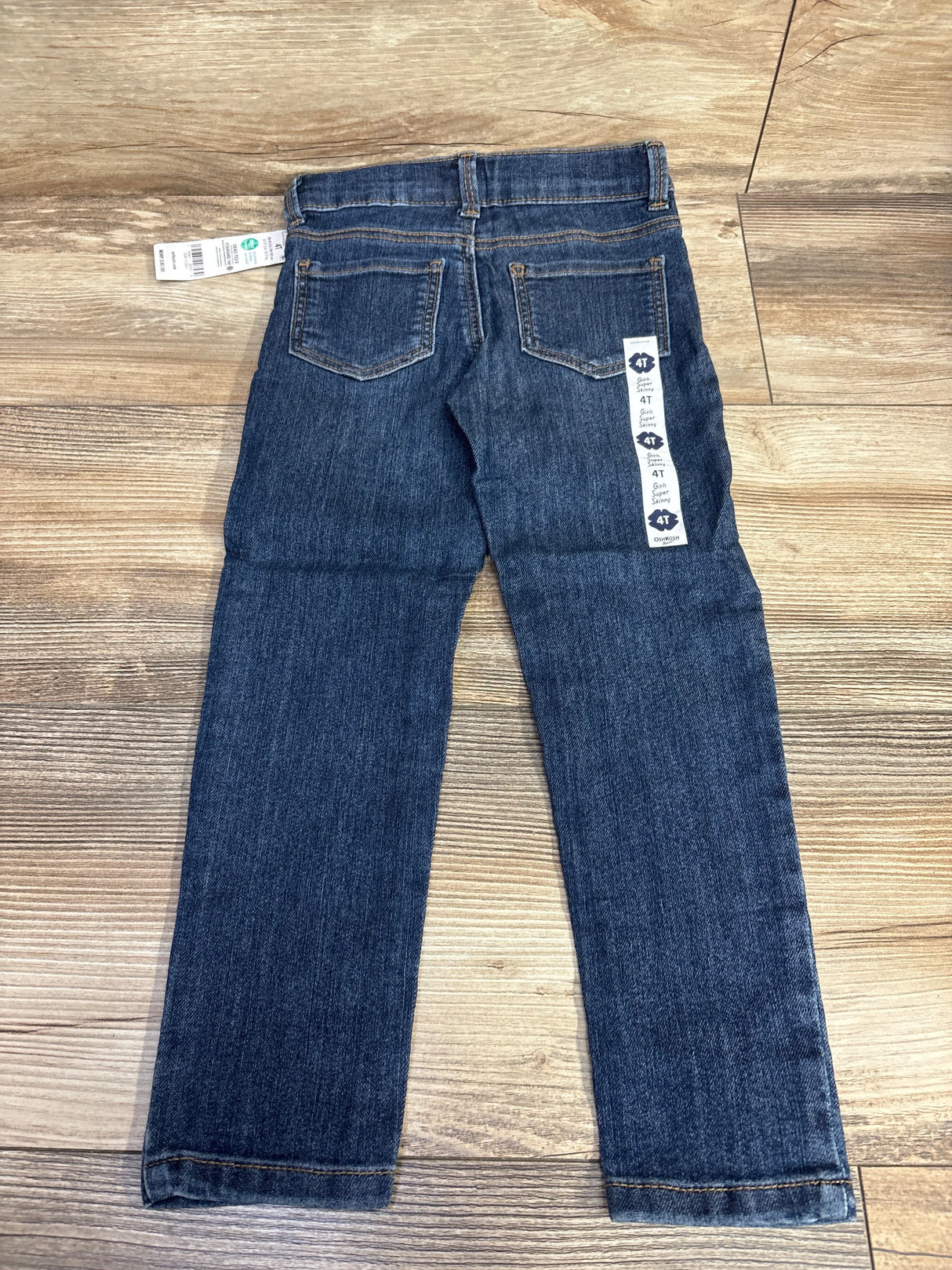 Dark blue toddler jeans size 4T with back pockets, displayed on wood floor