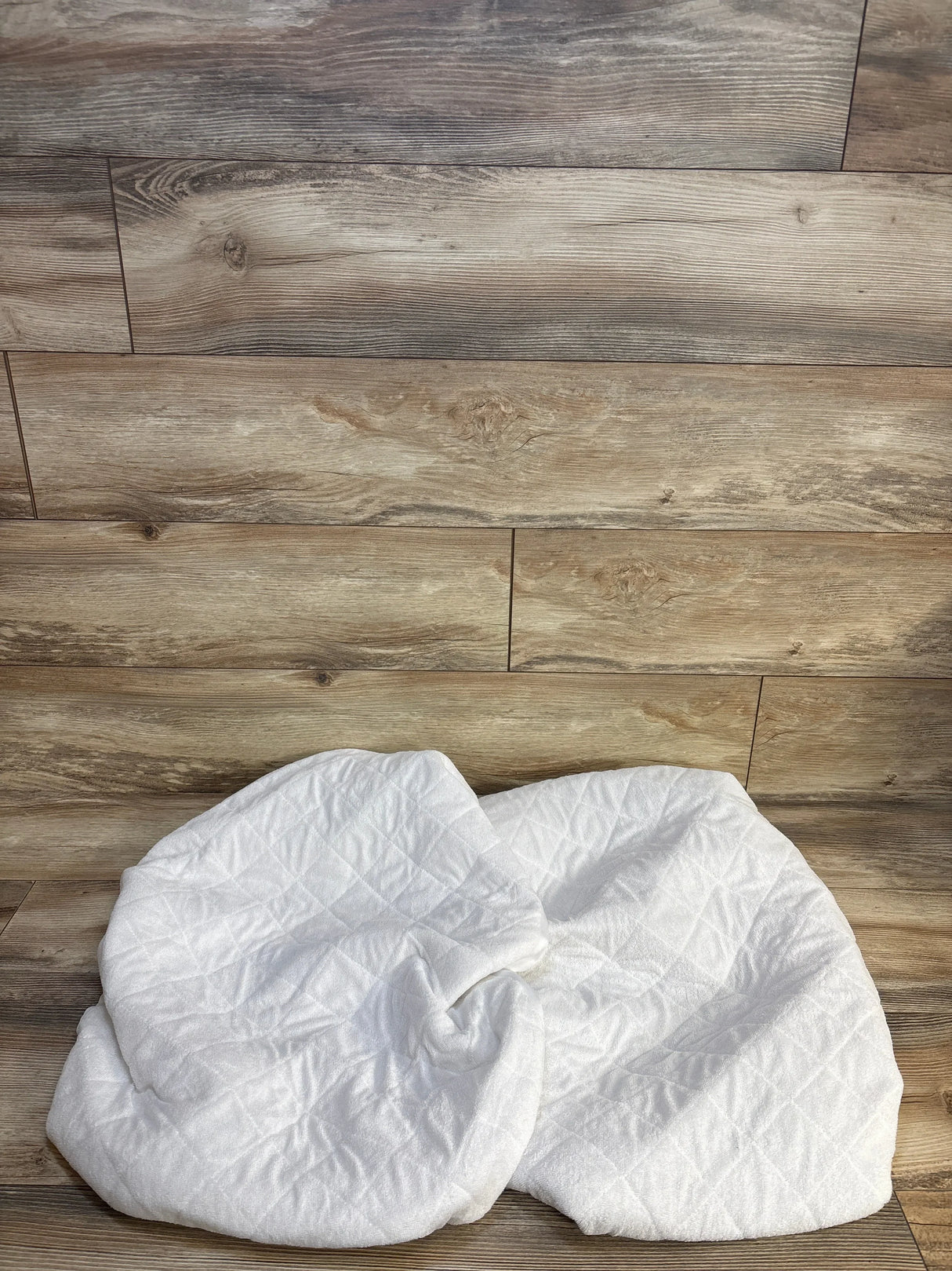 White quilted baby blanket on wood floor, soft newborn swaddle for maternity & kids resale