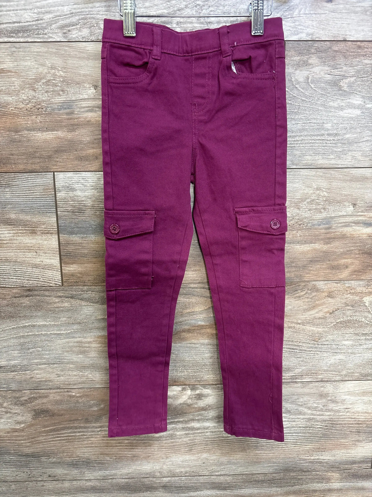 Front view of purple toddler Dreamstar jeans size 5T showcasing button-flap cargo pockets and slim fit on wood floor