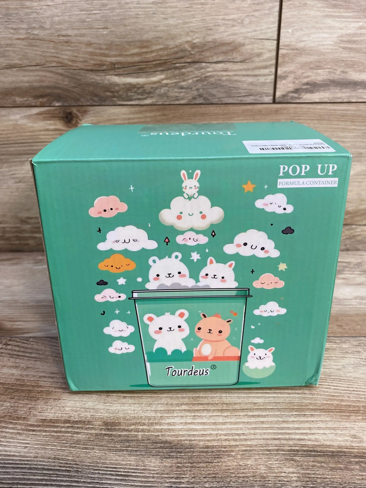 Front of Ankou Formula Container with teal packaging, cloud and animal illustrations, and 'POP UP Formula Container' label