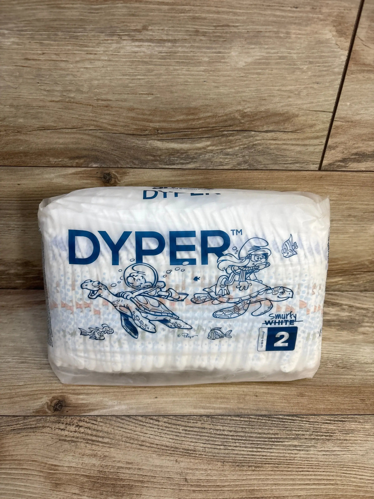 Dyper Smurfy White size 2 eco-friendly diapers with underwater Smurf design on wooden surface