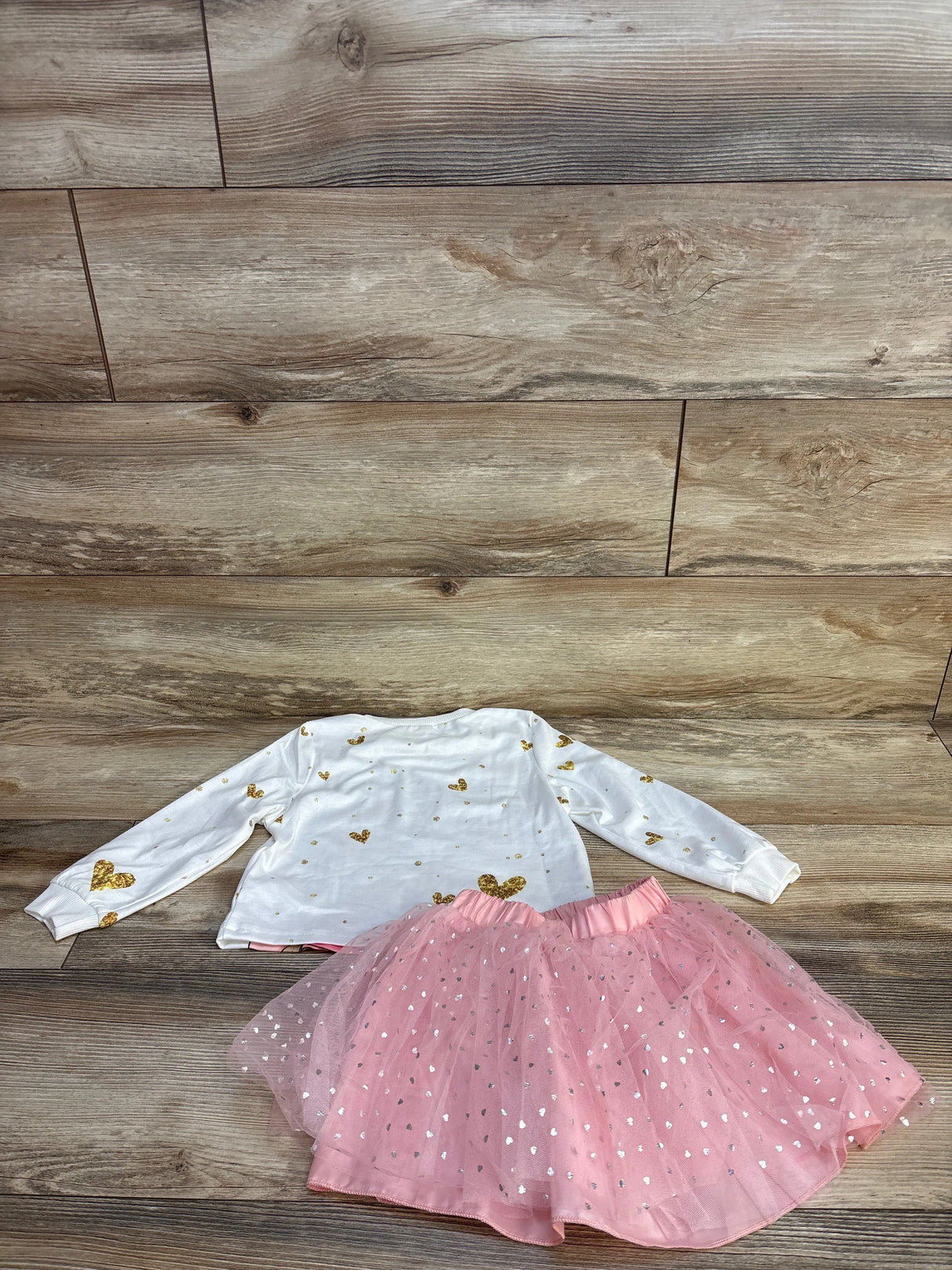 Pink tulle skirt with silver hearts and white long-sleeve top with gold hearts for kids
