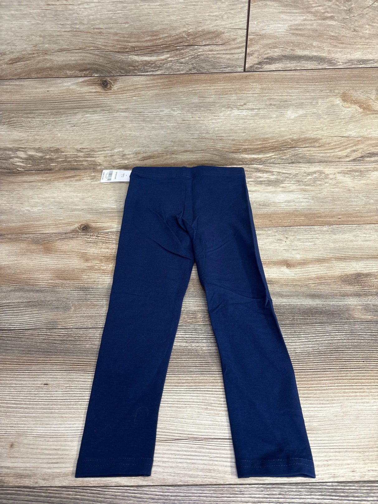 Navy blue toddler leggings on wood background, gently used kids clothing resale