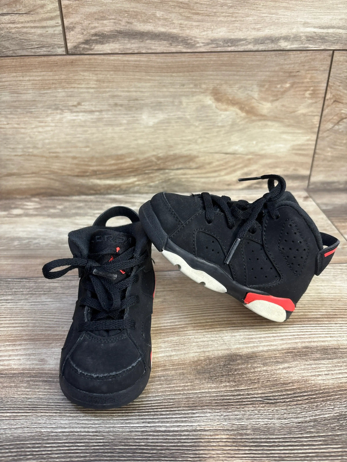 Front and side views of Air Jordan 6 Retro TD Infrared sneakers with black perforated suede, red accents, and two-tone outsoles