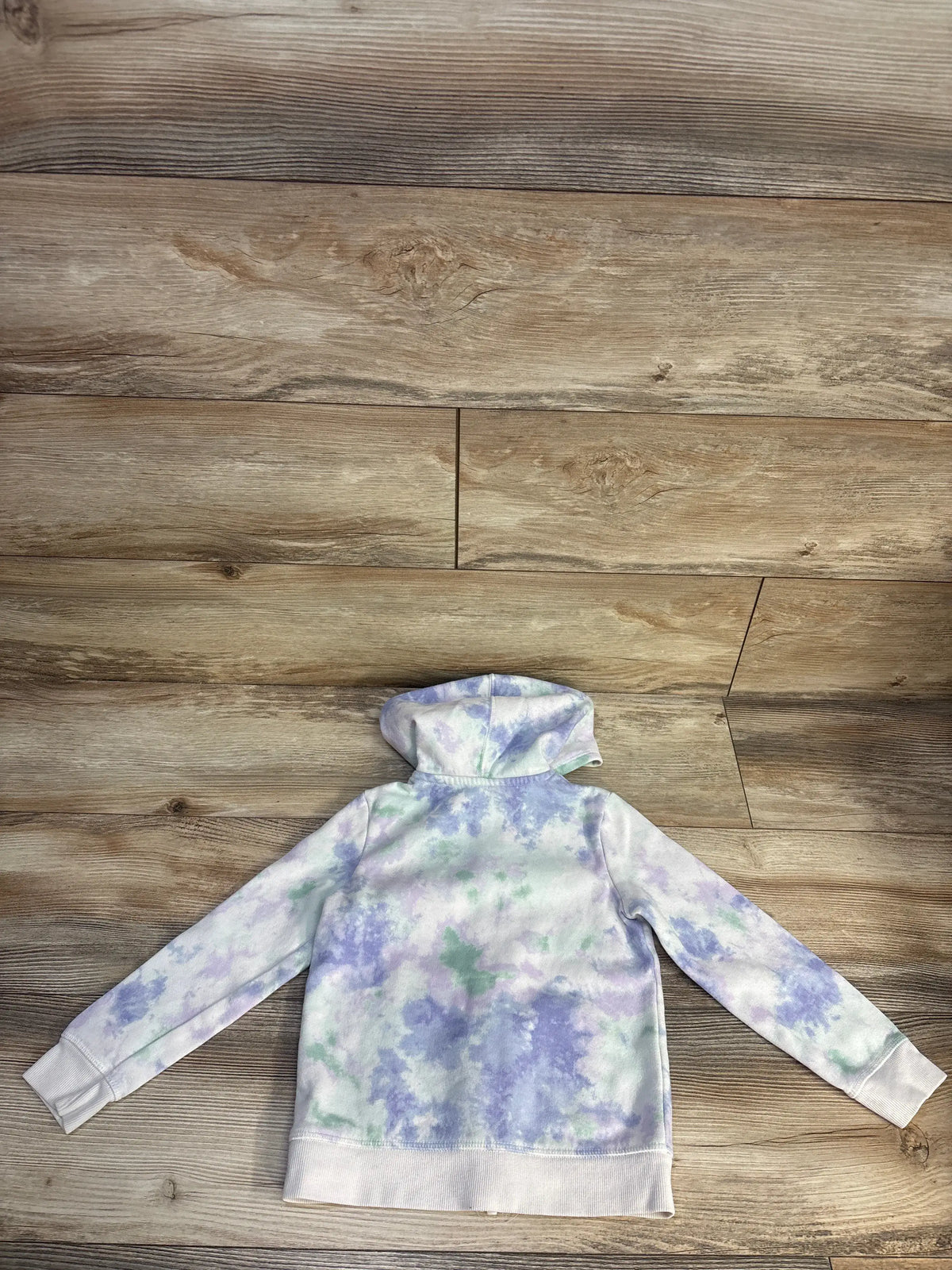 Back view of white Cat & Jack full zip jacket in size 5T showing hood, long sleeves, and ribbed cuffs on a wood floor