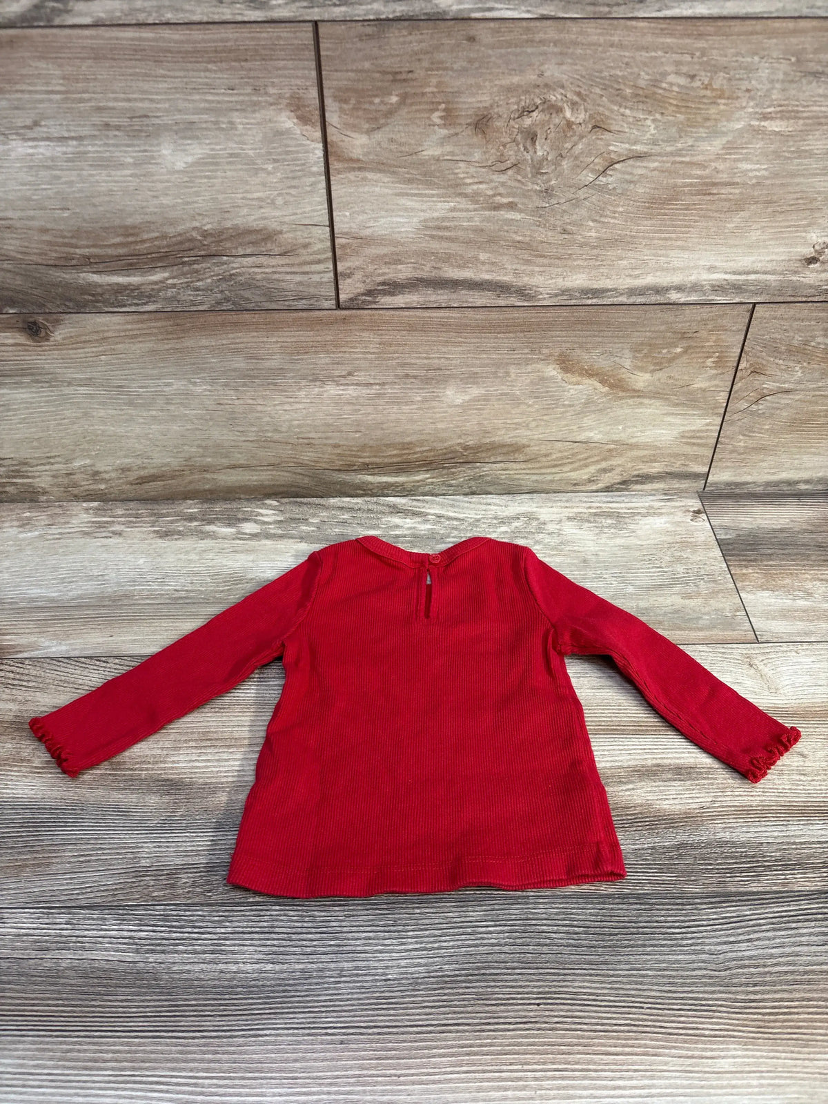 Baby Gap ribbed long sleeve red shirt for size 6-12m baby, displayed on a wooden background.