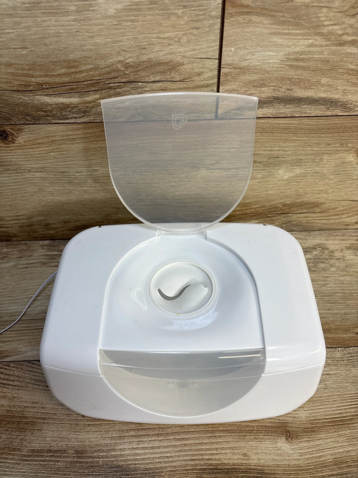 White baby bottle warmer with open lid on wood surface, ideal for maternity and baby gear