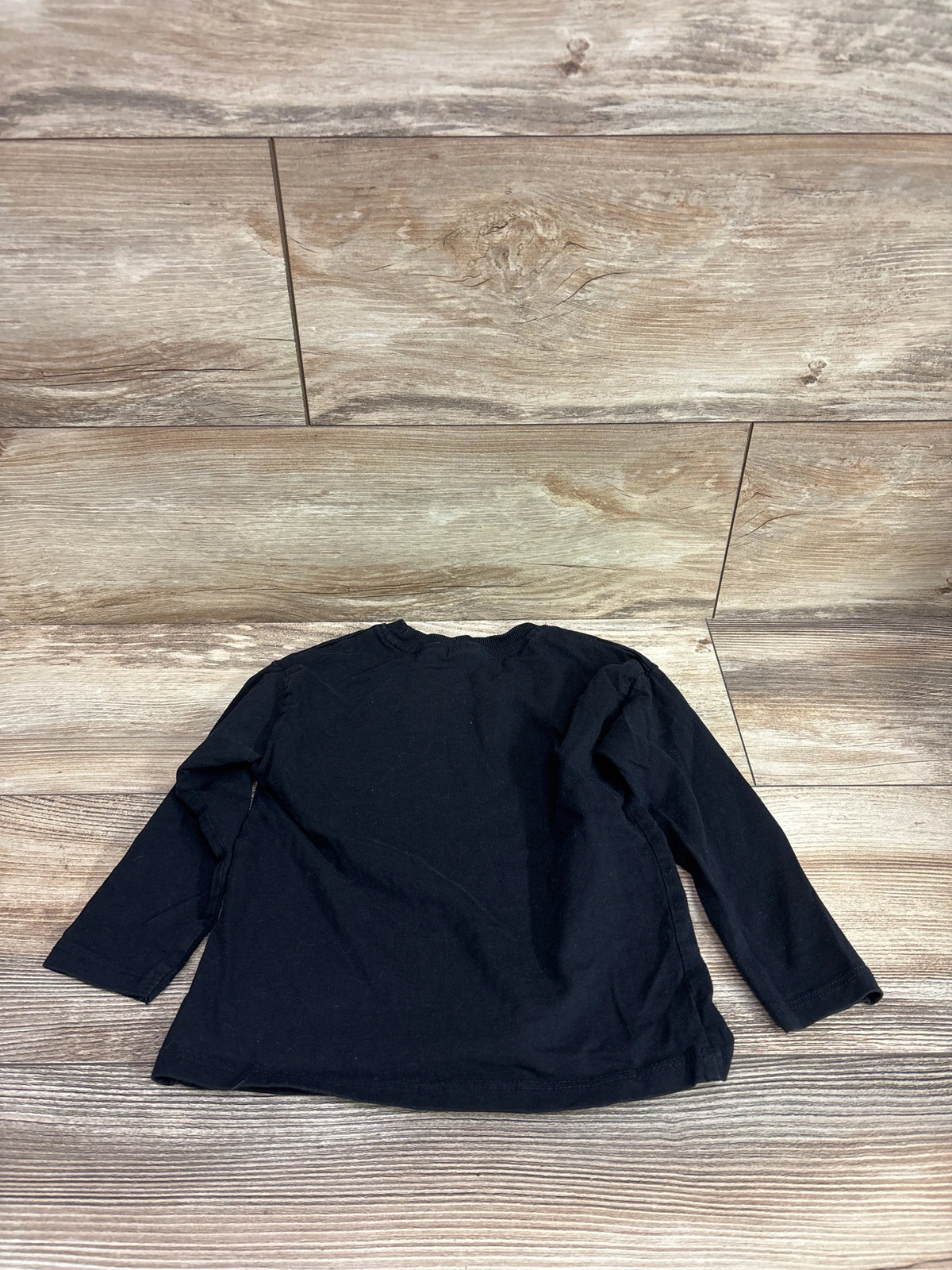 Black Zara long sleeve shirt for toddlers size 2-3T on a light wood background