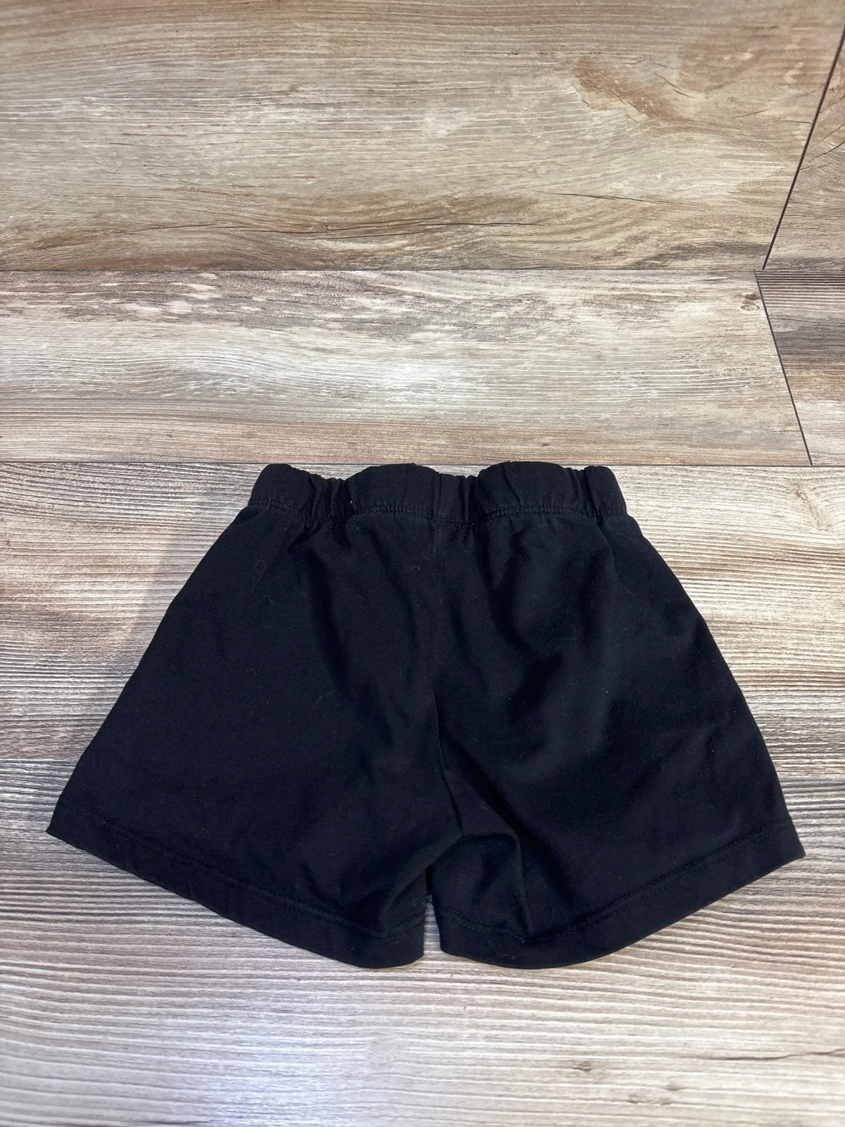 Front view of Children’s Place drawstring shorts showcasing elastic waistband and adjustable drawstring on a wood-look floor