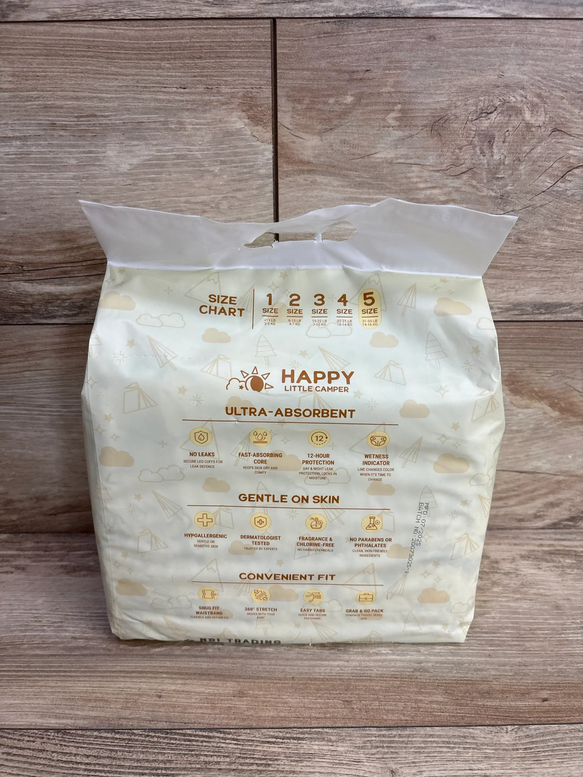 Pack of Happy Little Camper ultra-absorbent size 5 baby diapers on wood background