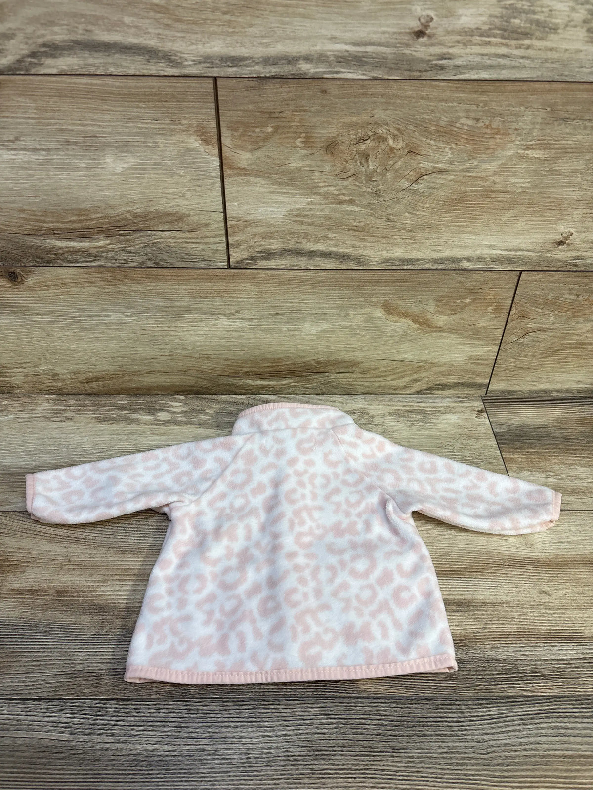 Pink and white leopard print fleece baby jacket by Me n Mommy To Be on wood background