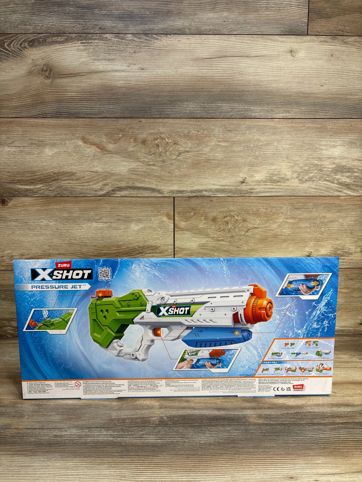 Zuru X-Shot Pressure Jet water blaster toy in box on wood background