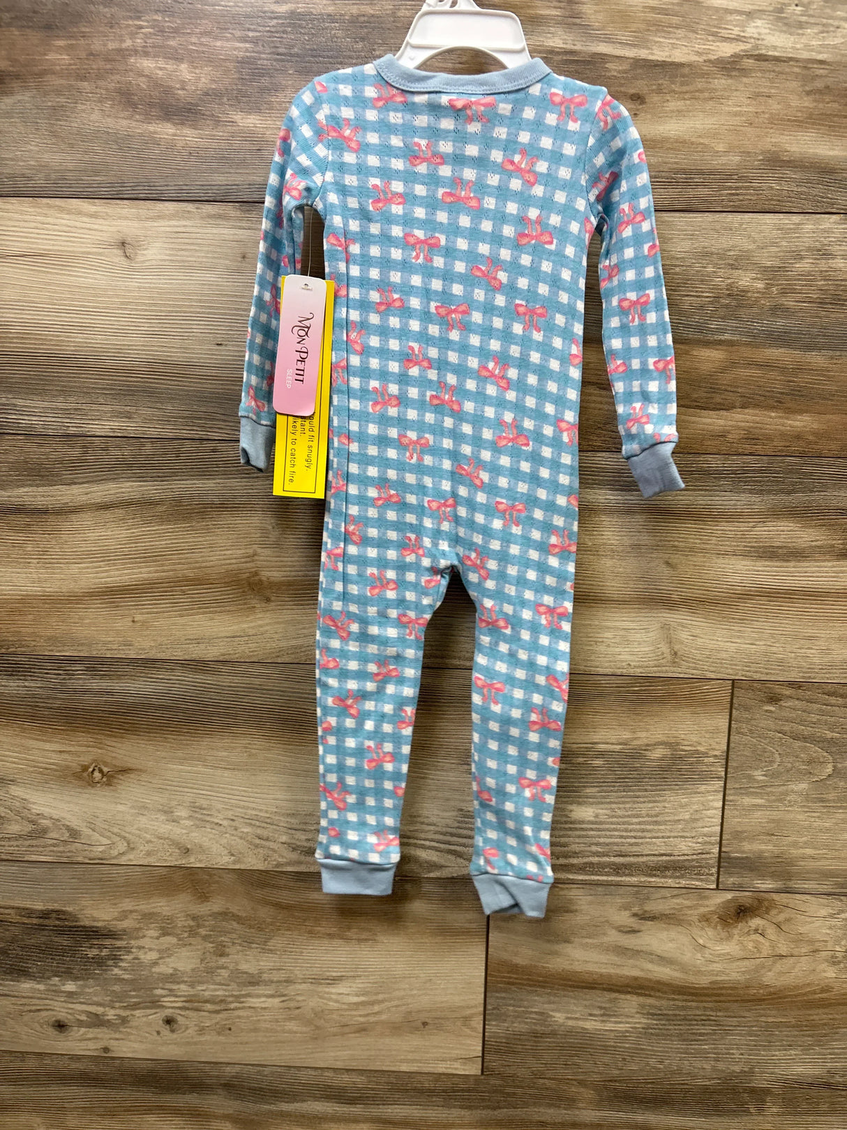 Blue gingham baby pajamas with pink bows, long-sleeve one-piece sleepwear on hanger