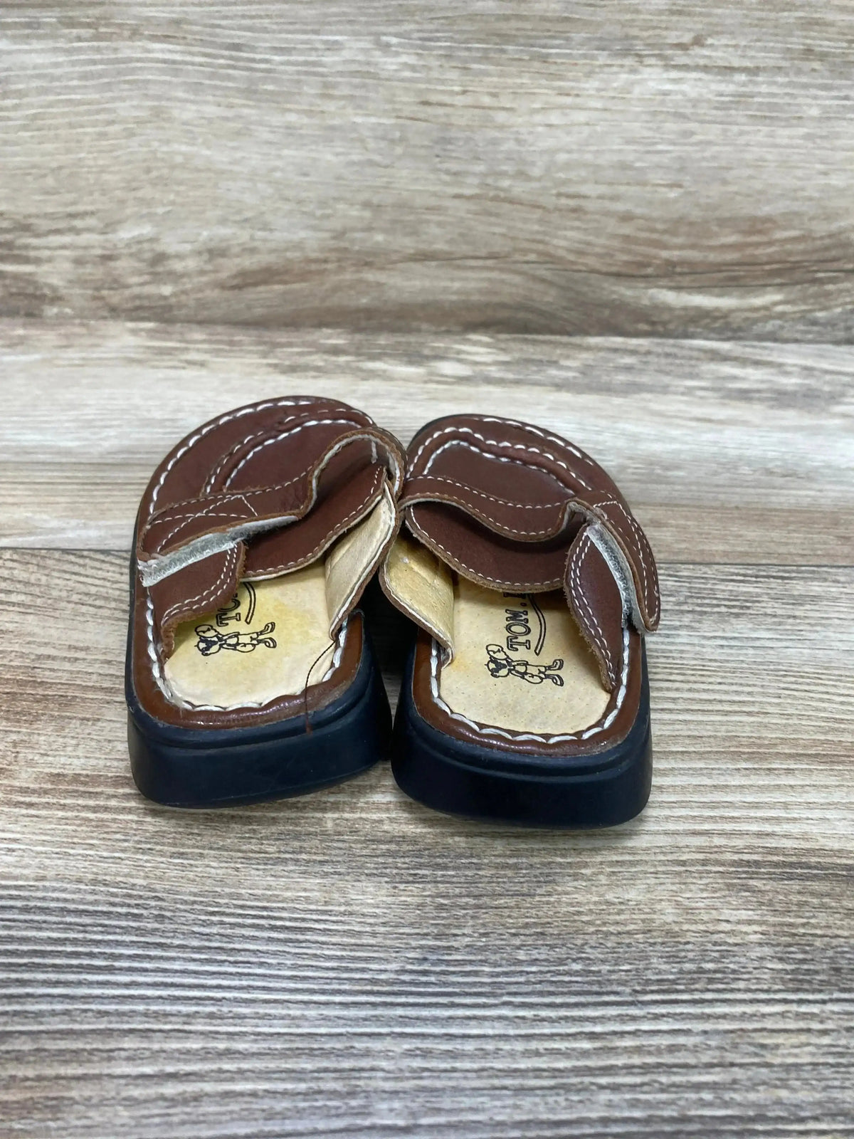 Three-quarter view of Tom Dog leather toddler clogs size 5/6C showing slip-on design and stitching on white background