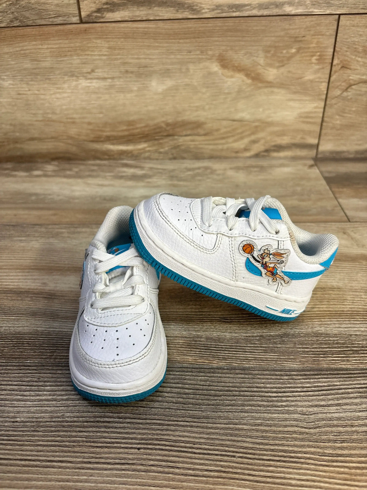 Angled view of Nike Air Force 1 TD x Space Jam Hare sneakers with Light Blue Fury overlays and Bugs and Lola details