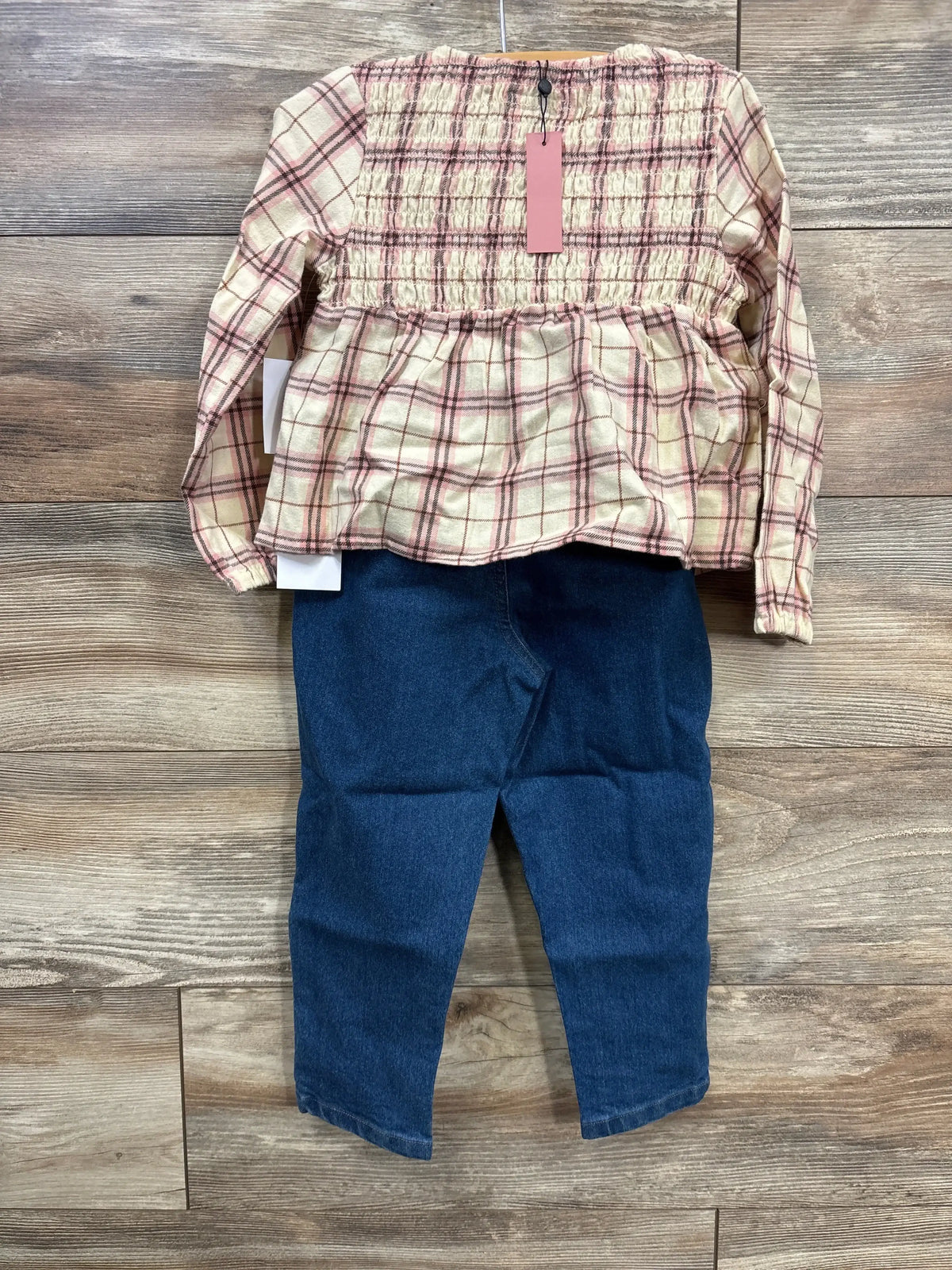 Plaid long sleeve shirt with smocked bodice and blue denim jeans for kids on wooden floor