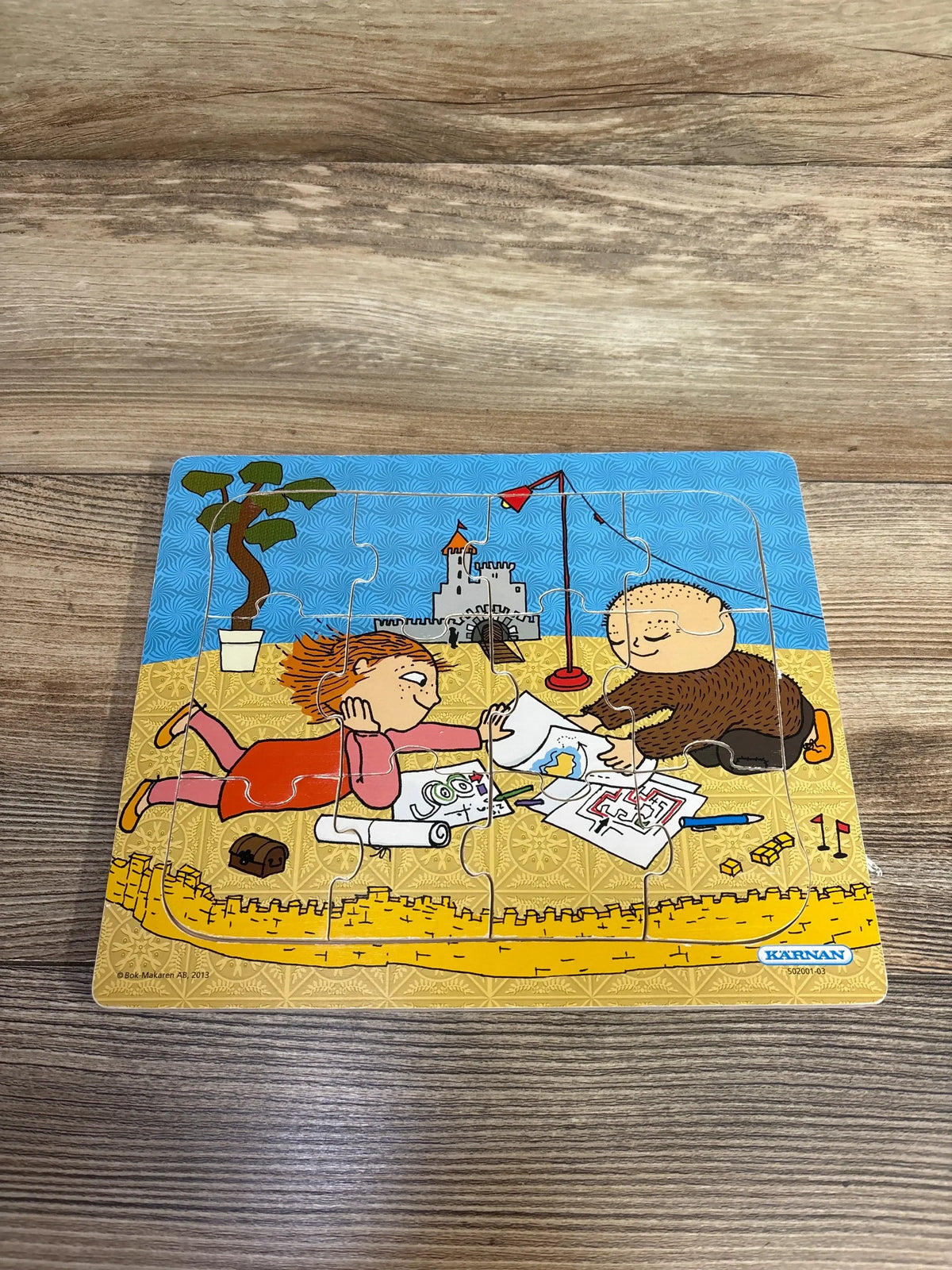 Children's beach puzzle with kids drawing near sandcastle, colorful illustration