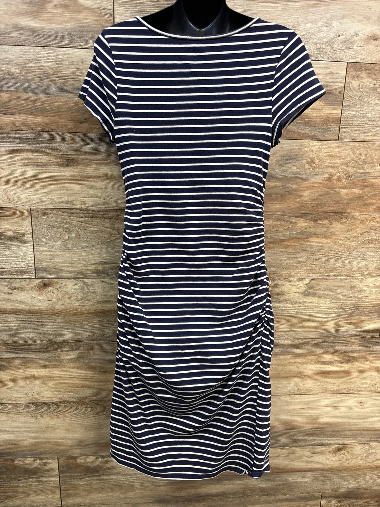 Navy and white striped short sleeve dress with side ruching on wood background