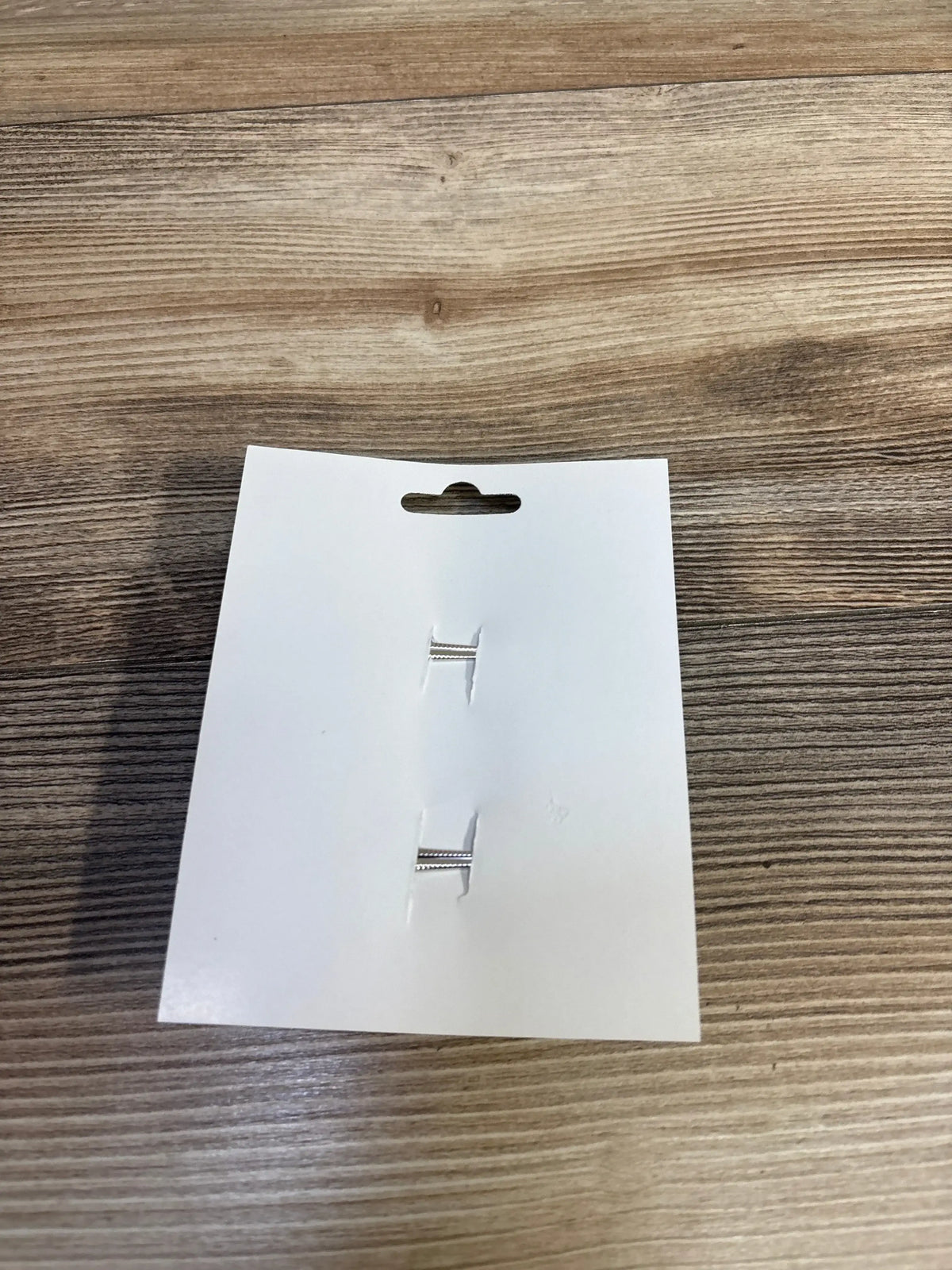 Silver H-shaped hair clips on white card, kids accessories for sale
