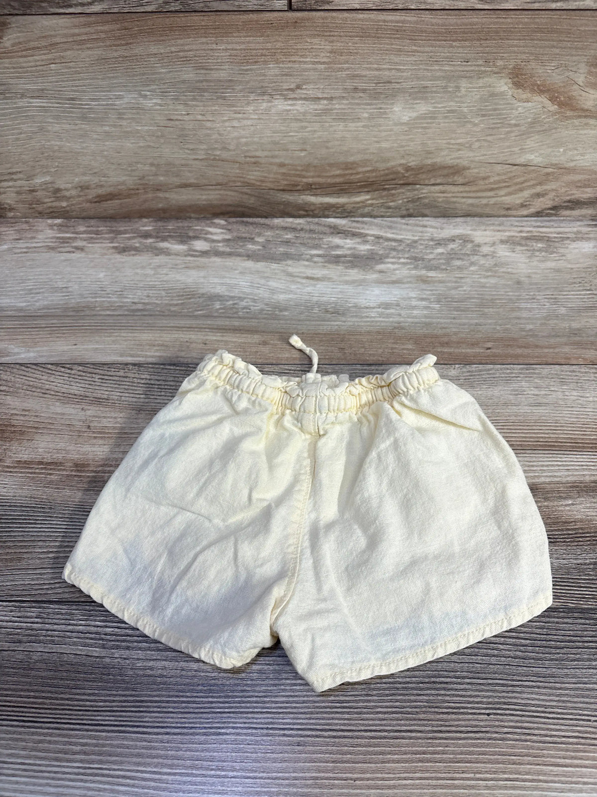 Old Navy yellow linen blend toddler shorts for size 18-24m on a wood background
