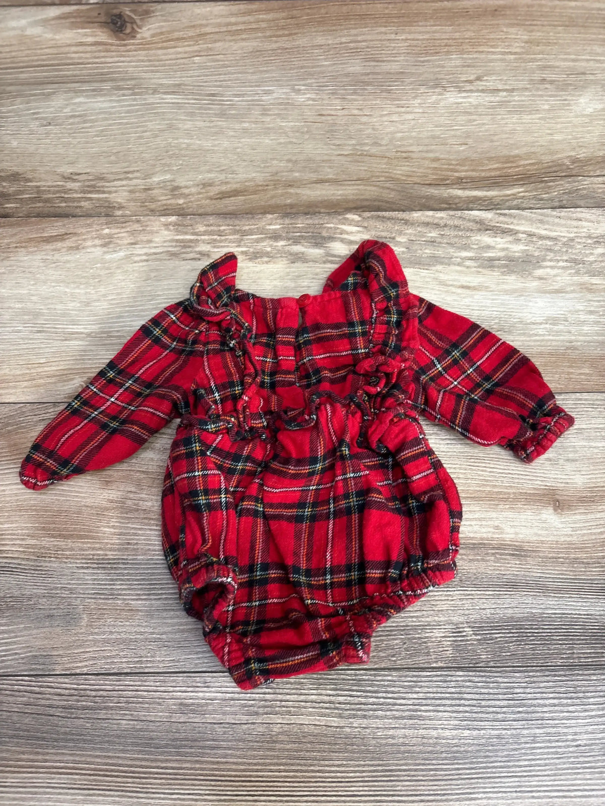 Red plaid baby onesie with ruffles, perfect for holiday outfits and cozy days.