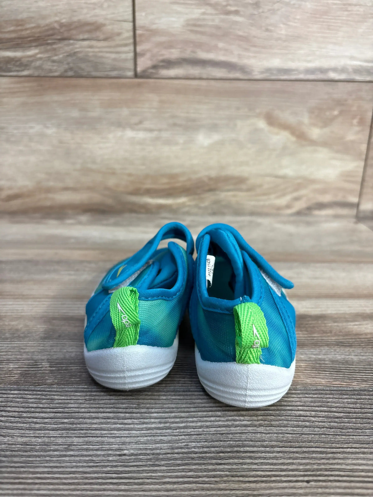 Rear view of Speedo Shore Explorer water shoes showcasing mesh uppers and easy closure on a wood-patterned surface