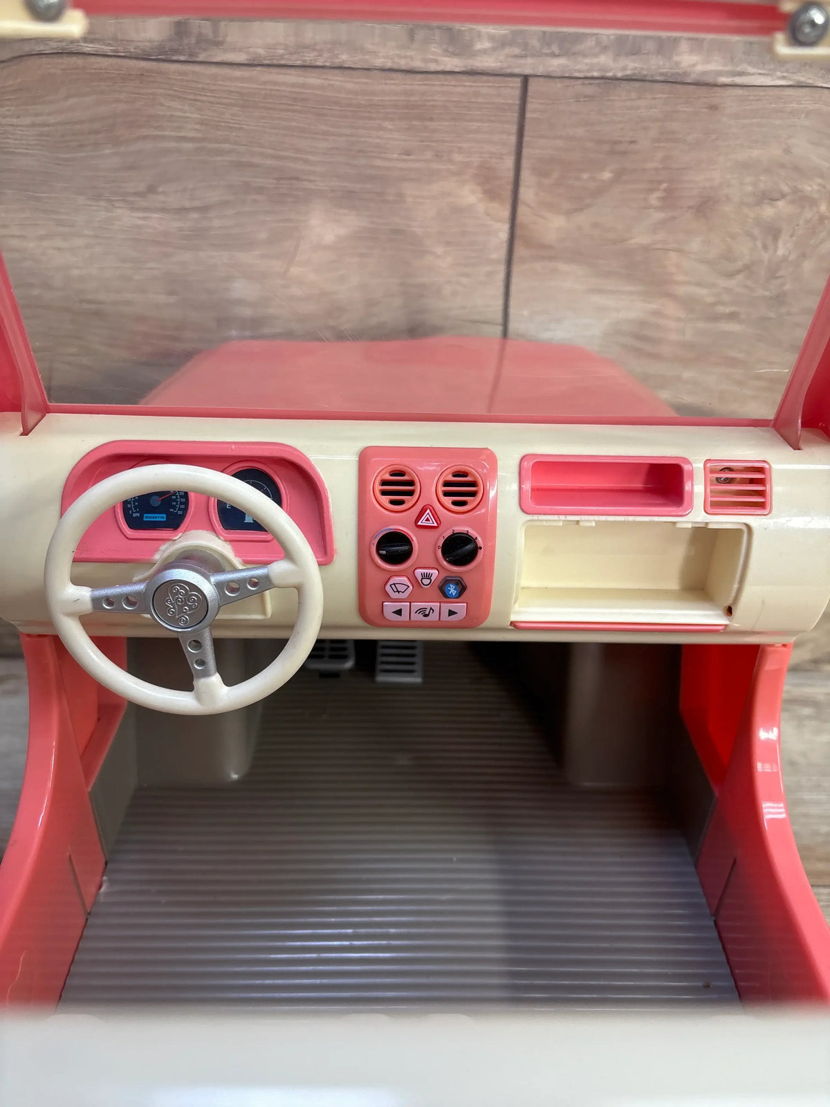 Front interior view of Our Generation Off-Roader 4x4 Doll Vehicle in Pink showcasing steering wheel and dashboard controls