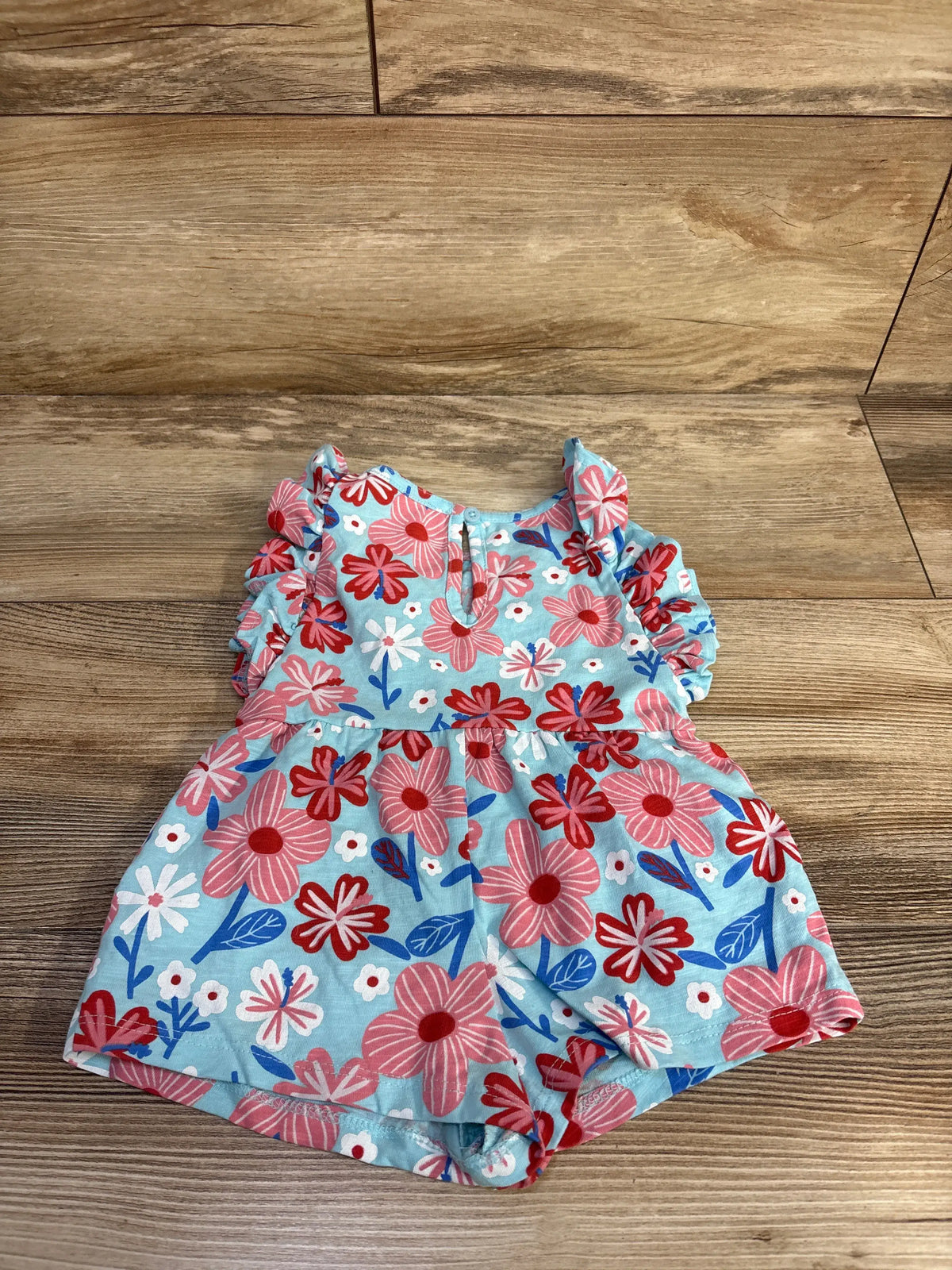 Front view of light blue floral shortie romper size 6-12 months showing short sleeves and snap crotch on white background