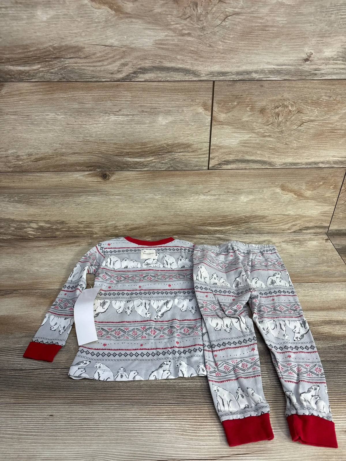 Children's holiday pajama set with polar bear and snowflake patterns, red cuffs on sleeves and pants