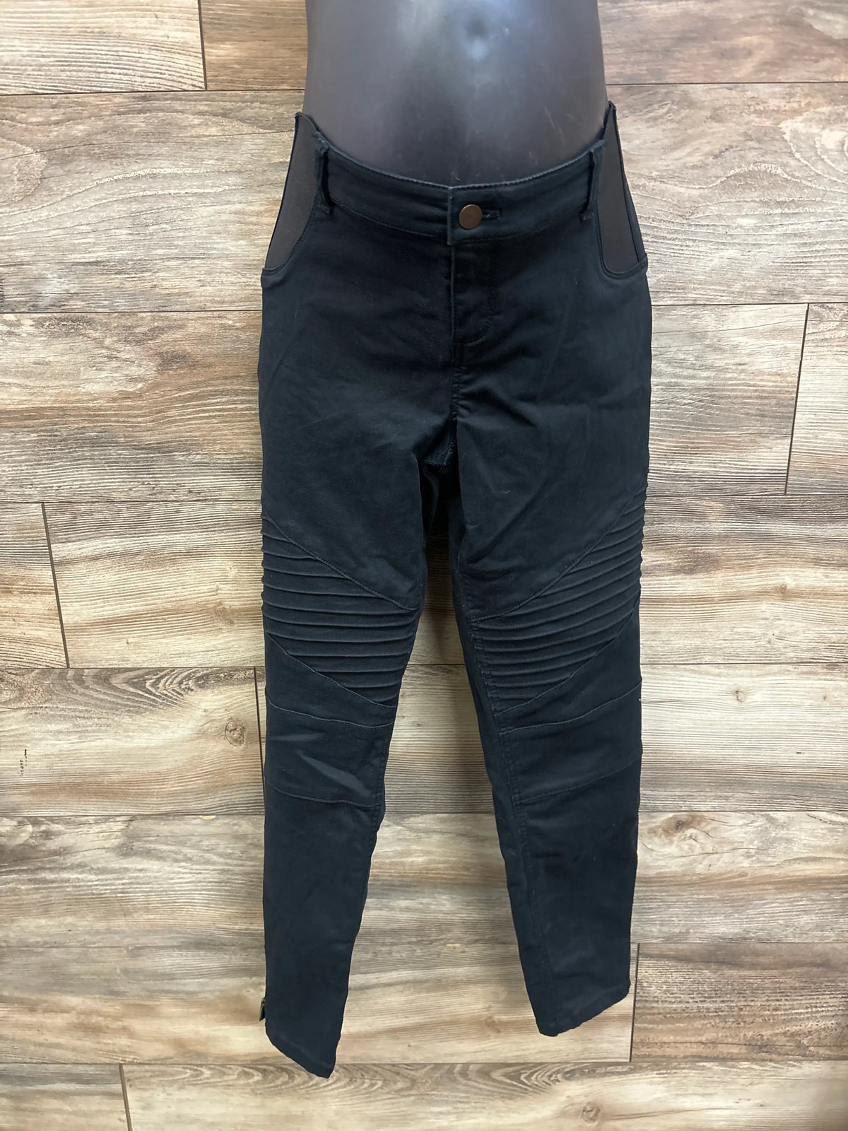 Front view of Isabel black maternity side panel jeggings showcasing ruched knee detailing on wood flooring