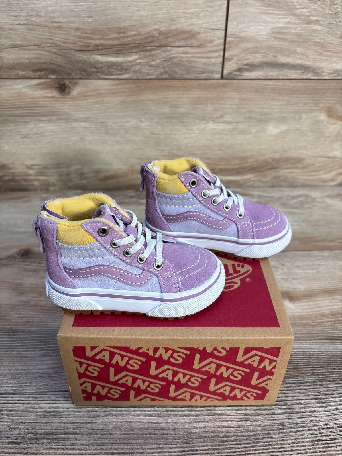 Front and side view of purple Vans MTE Sk8 Hi-Zip toddler sneakers showcasing back zippers and elastic laces on a Vans box