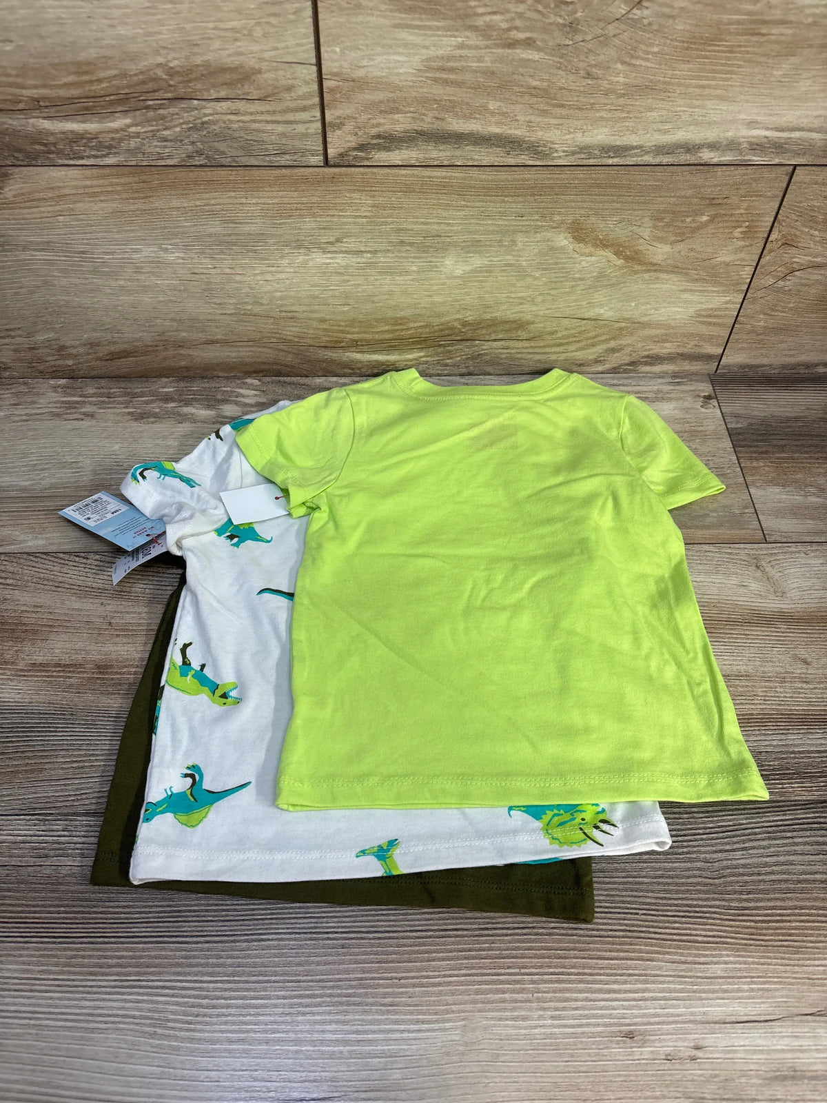 New Cat & Jack 3-pack of baby boy shirts in lime green, white with dinosaurs, and olive green.