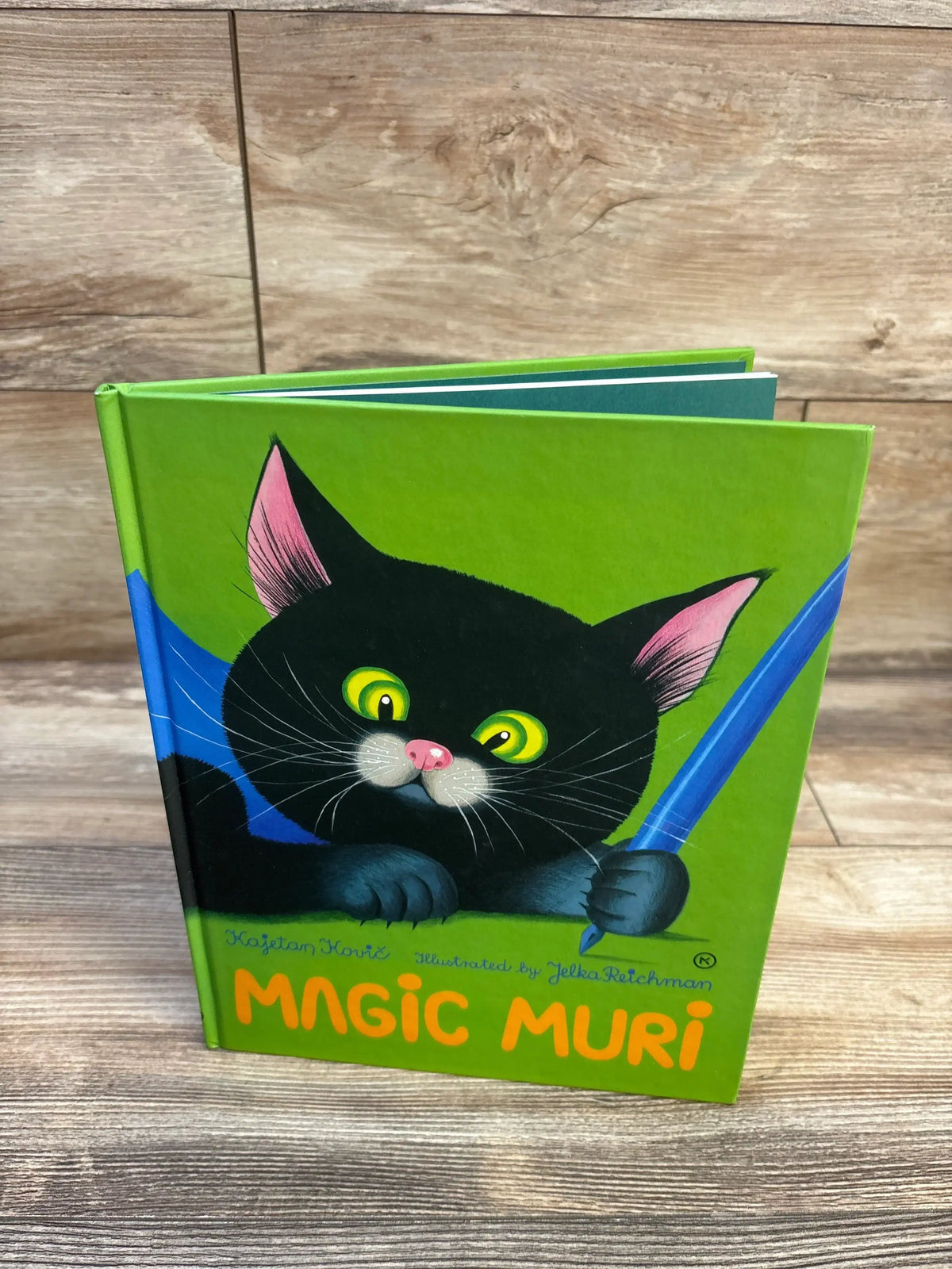 Magic Muri children's book with black cat illustration, green cover, ideal for kids' storytime and early reading