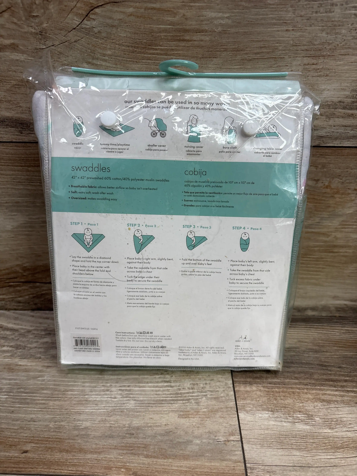 Back view of Ideal Baby 3pk muslin swaddle blankets showing 42 by 42 inch size and swaddling instructions in clear packaging