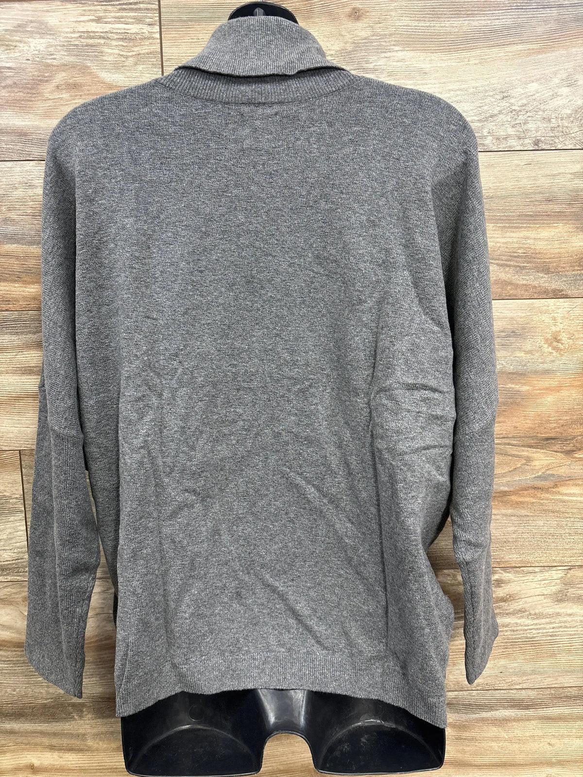 Back view of gray maternity turtleneck sweater size L, relaxed fit with ribbed collar on black mannequin, wood background
