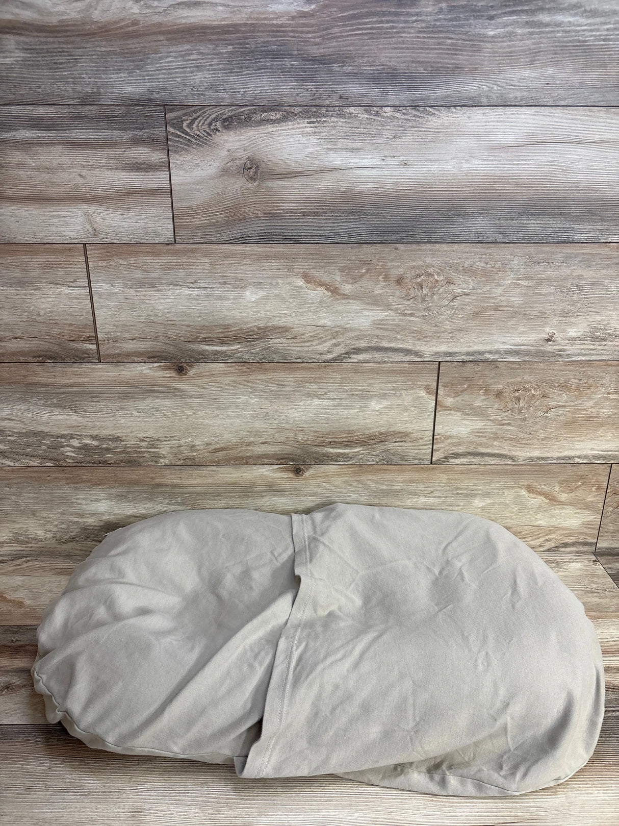Light gray pillowcase on rustic wooden floor background