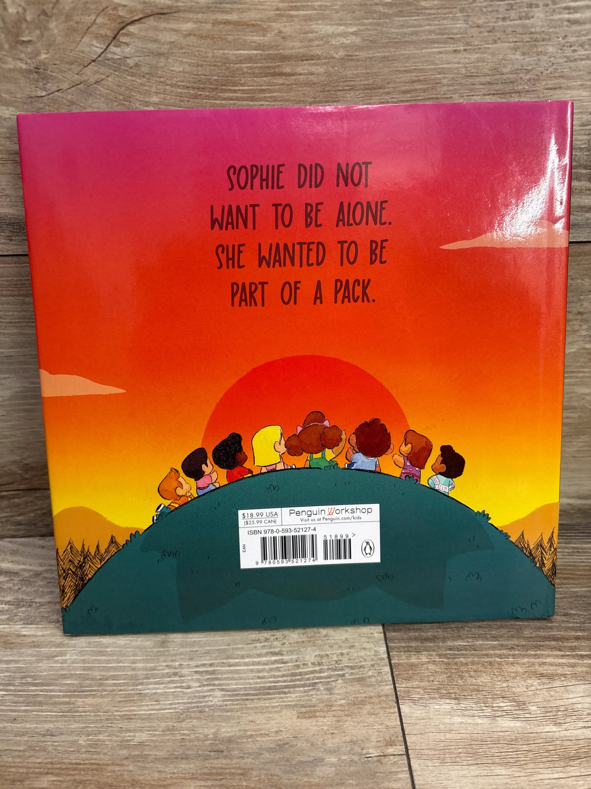Back cover of First Night of Howlergarten hardcover book with children on a hill and text, Sophie wanted to be part of a pack